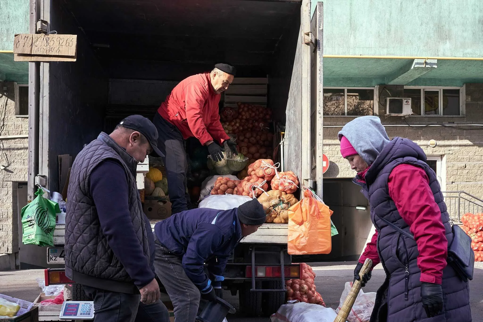 Jerzy Jaworek, Street and Travel Photography, Kazakhstan, Almaty. People buying onions from a truck at a street market.