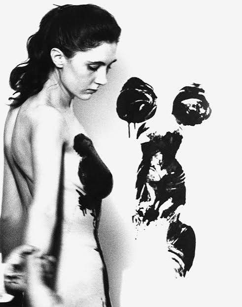 Here is one of Klein's models in front of a print of her body. Notice Klein's hand in the lower left.