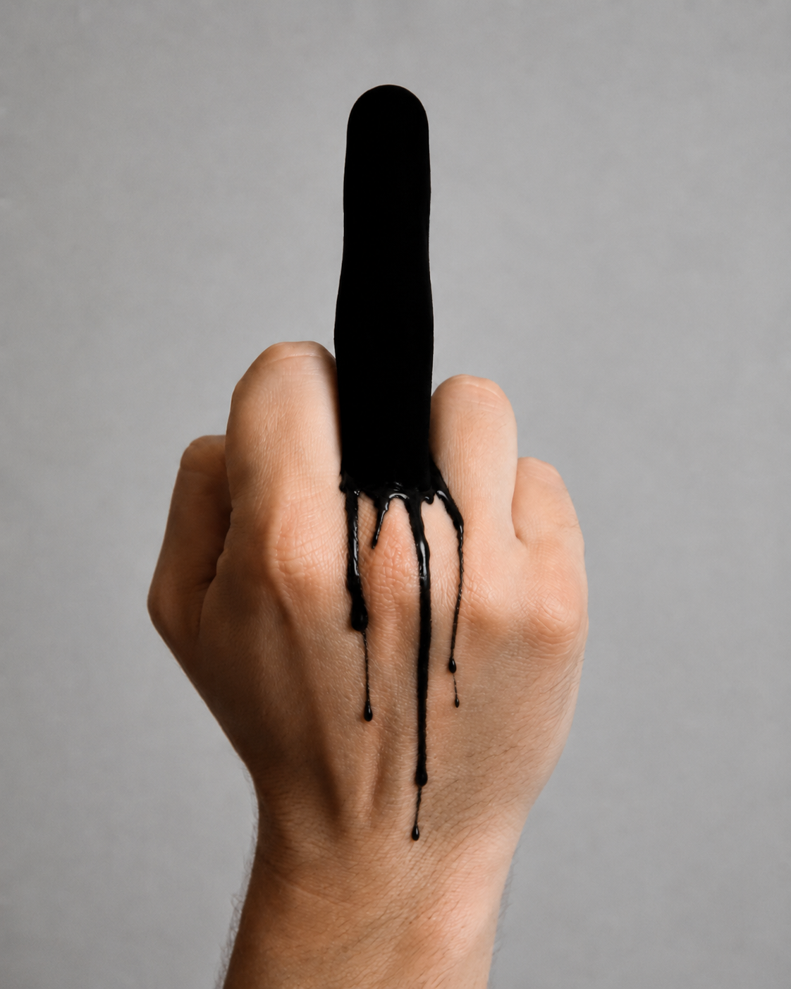 A hand with its third finger extended (ie flipping the bird). The finger is covered in vantablack and looks like the blacked finger ever. Black paint drips down onto the rest of the hand.
