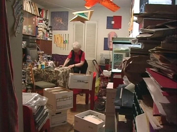 Dorothy Vogel, art collector and librarian is sorthing thorugh the artwork that covers every corner and surface of her modest apartment.