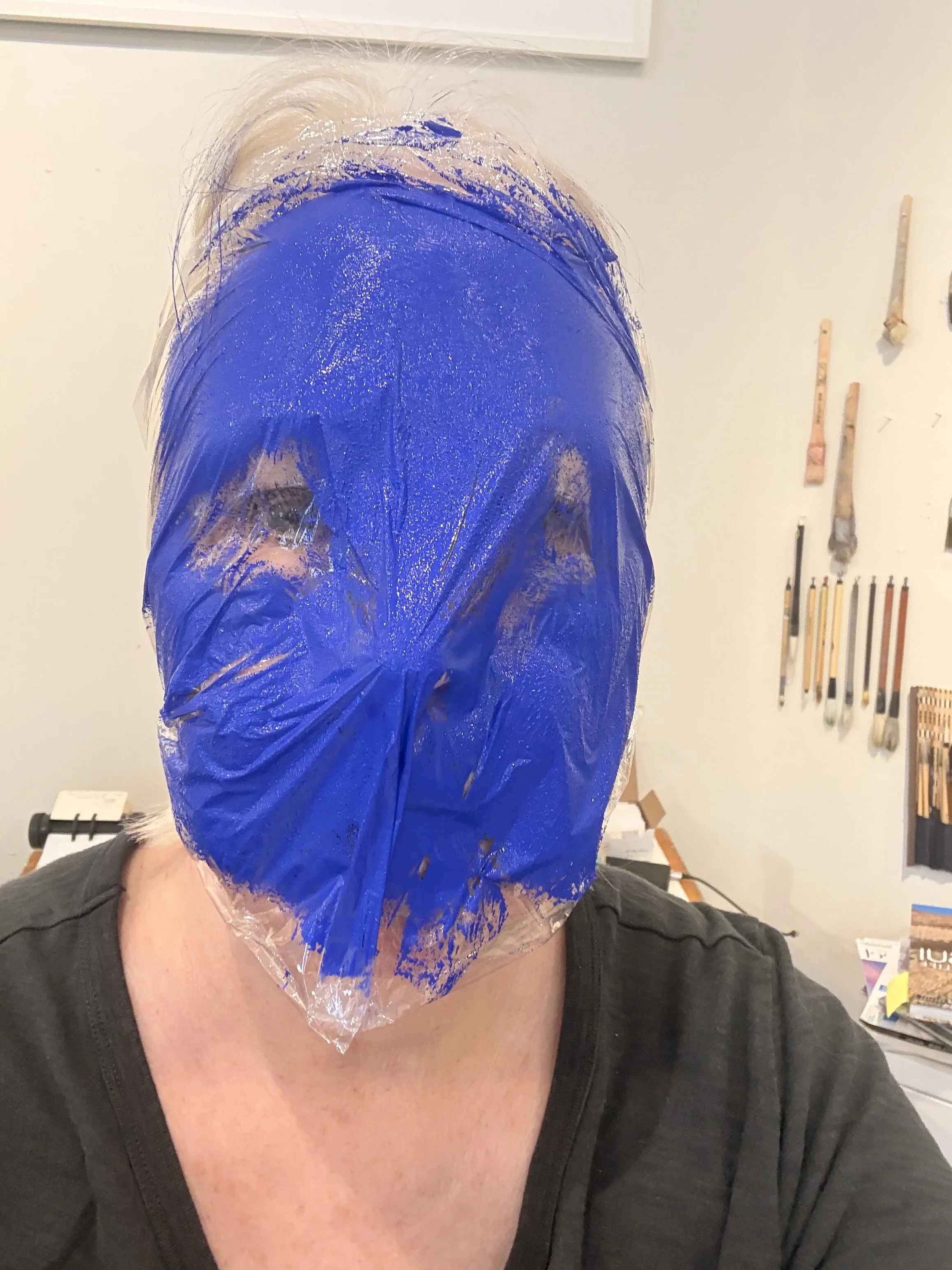 Since I was using oil paint, I first covered my face with plastic. 