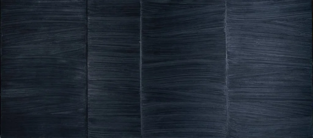 A black painting with four distinct areas of horizontal marks in the paint that show up as the light reflects on them.