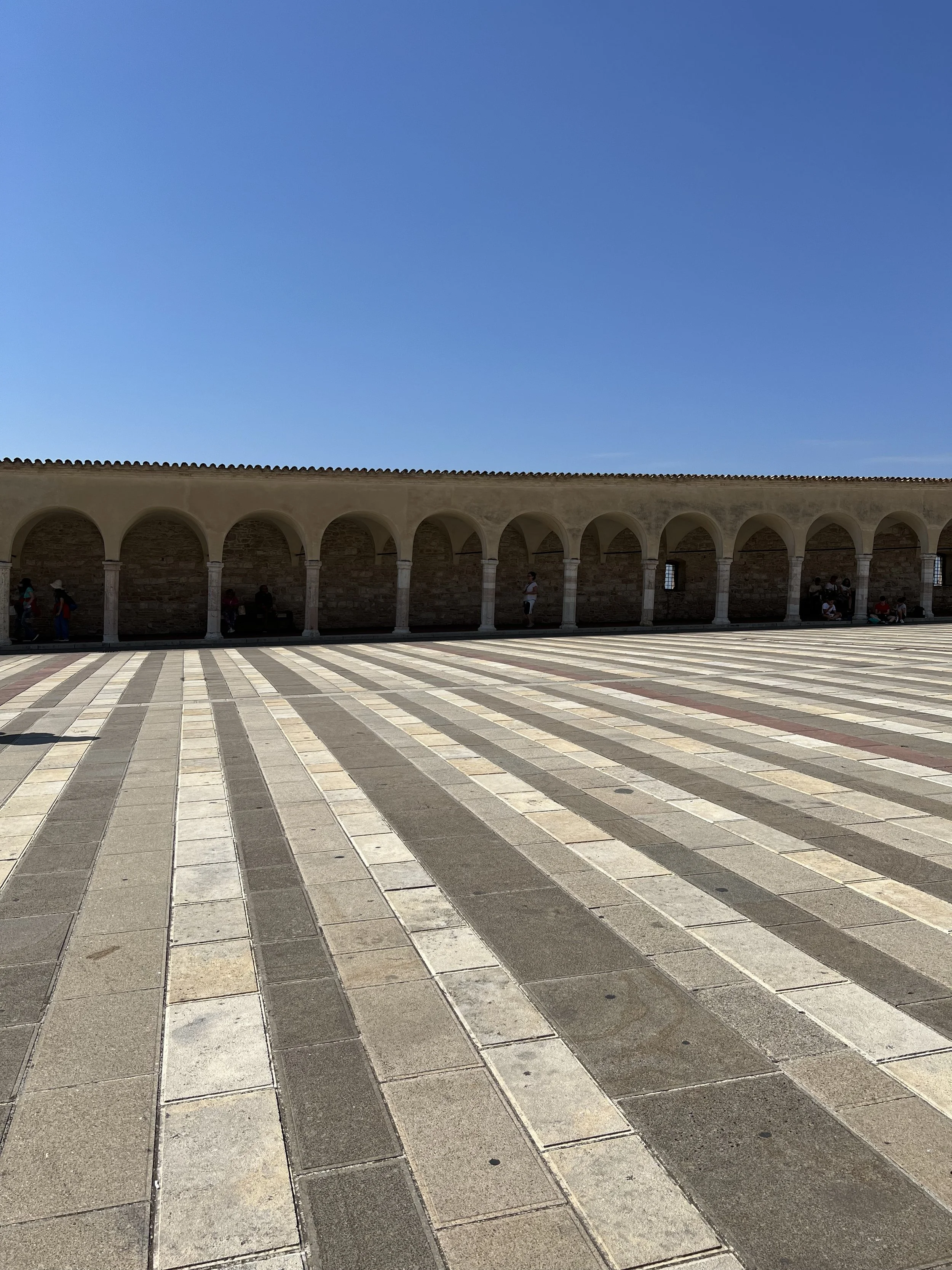 In Assisi you can see this in the plaza put there centuries before Pat Johanson took the stripe to the landscape, or Gene Davis painted the streets of Washington.
