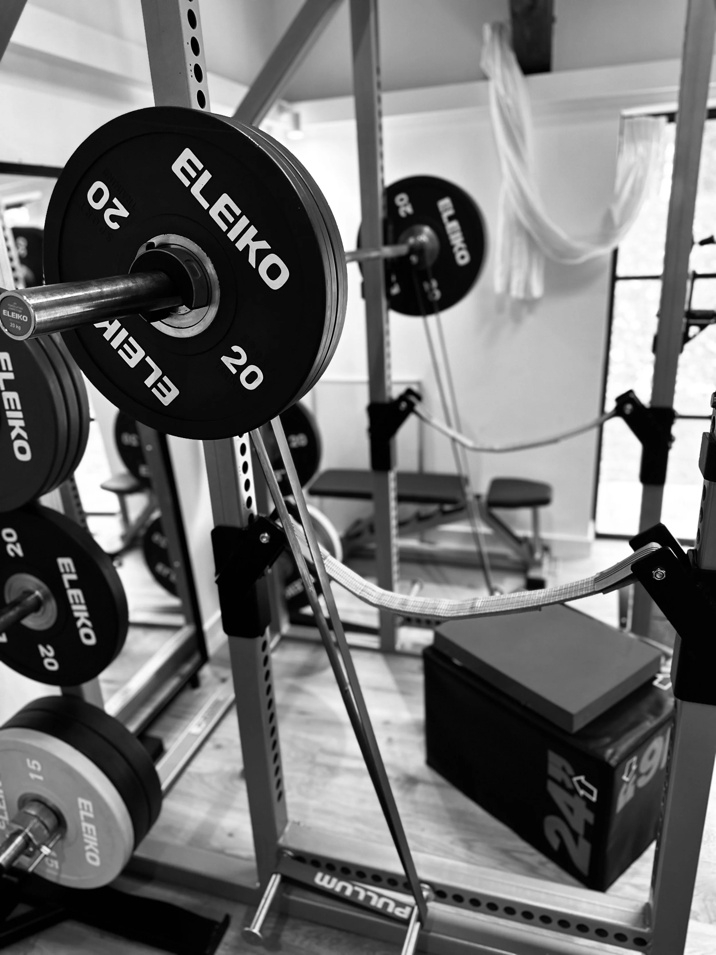 Close-up of a hand holding a stethoscope on a person's abdomen.