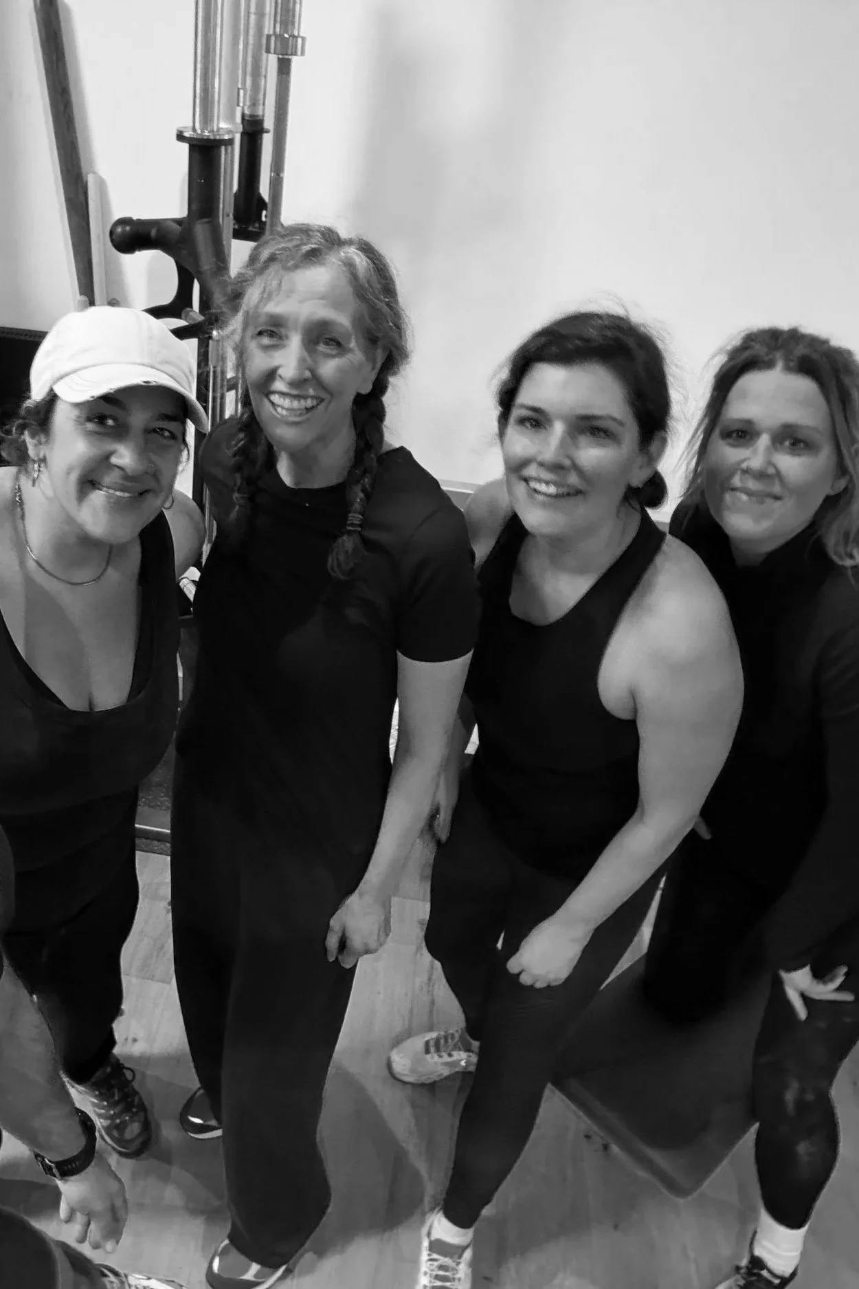 Person lying on a couch using a smartphone, with a snowboard placed on their legs and a large DAKINE logo on the snowboard.