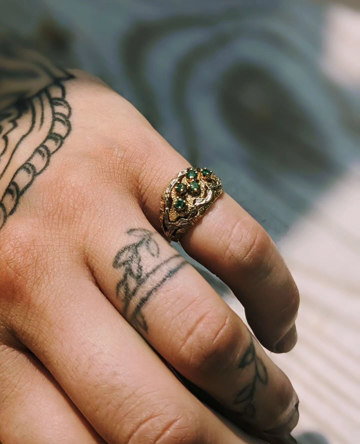 Another antique stunner for ya! 5 natural green Emeralds are set into a yellow and white 18k gold, unique, freeform, textured thick band.  US size 4. Can be resized upon request. Ring will arrive in a burgundy velvet presentation box. Currently avail