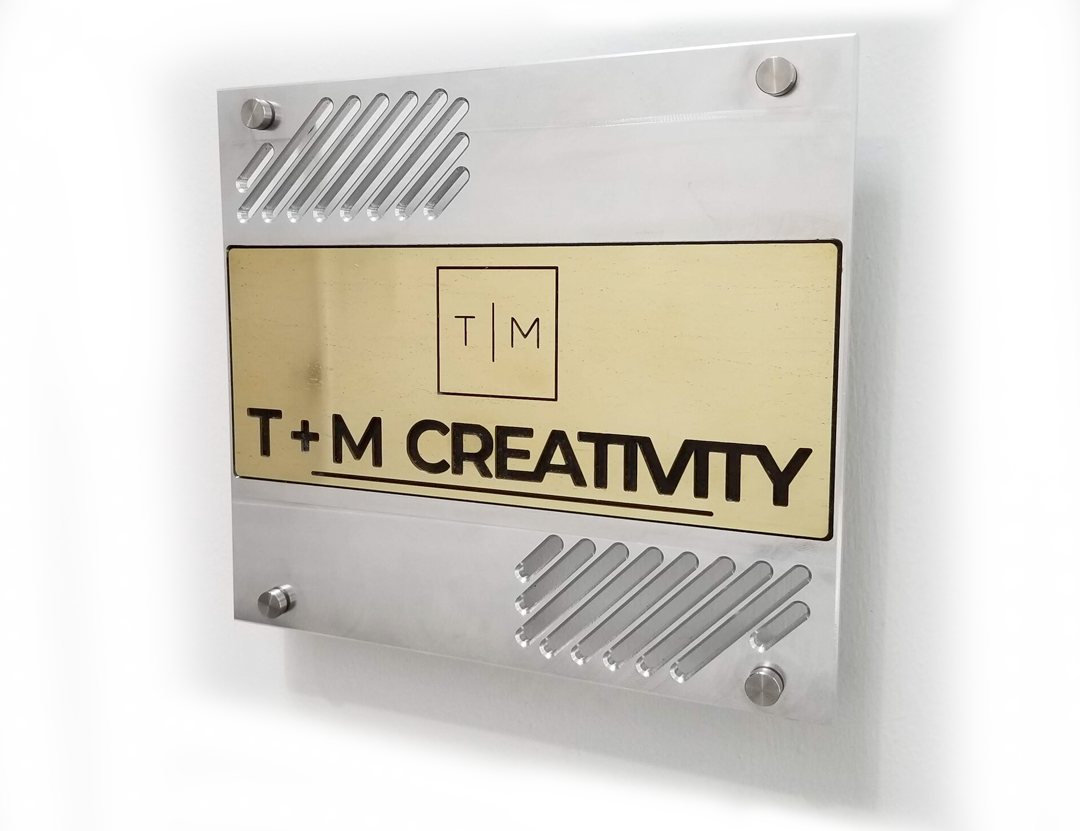 TMCreativity Company sign and logo.  TMCreativity is a metal machine shop doing precision machining