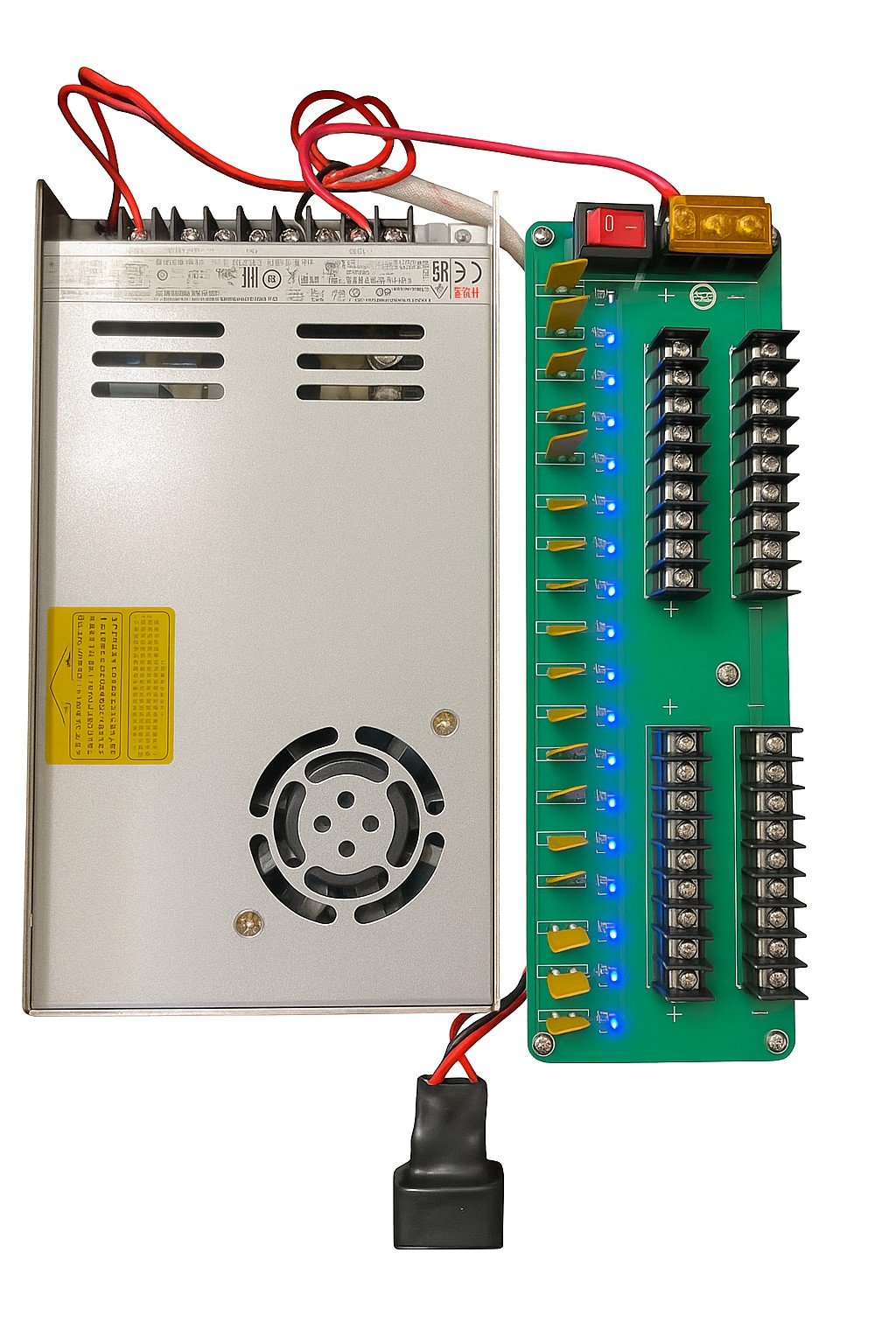 A power supply connected to a green circuit board with multiple blue indicator lights and black terminal blocks.