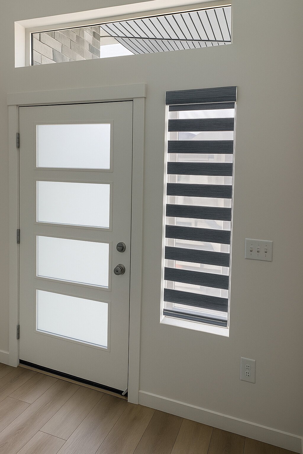 Interior view of a modern entryway with a white door featuring four frosted glass panels and a rectangular window with dark blinds to the right.