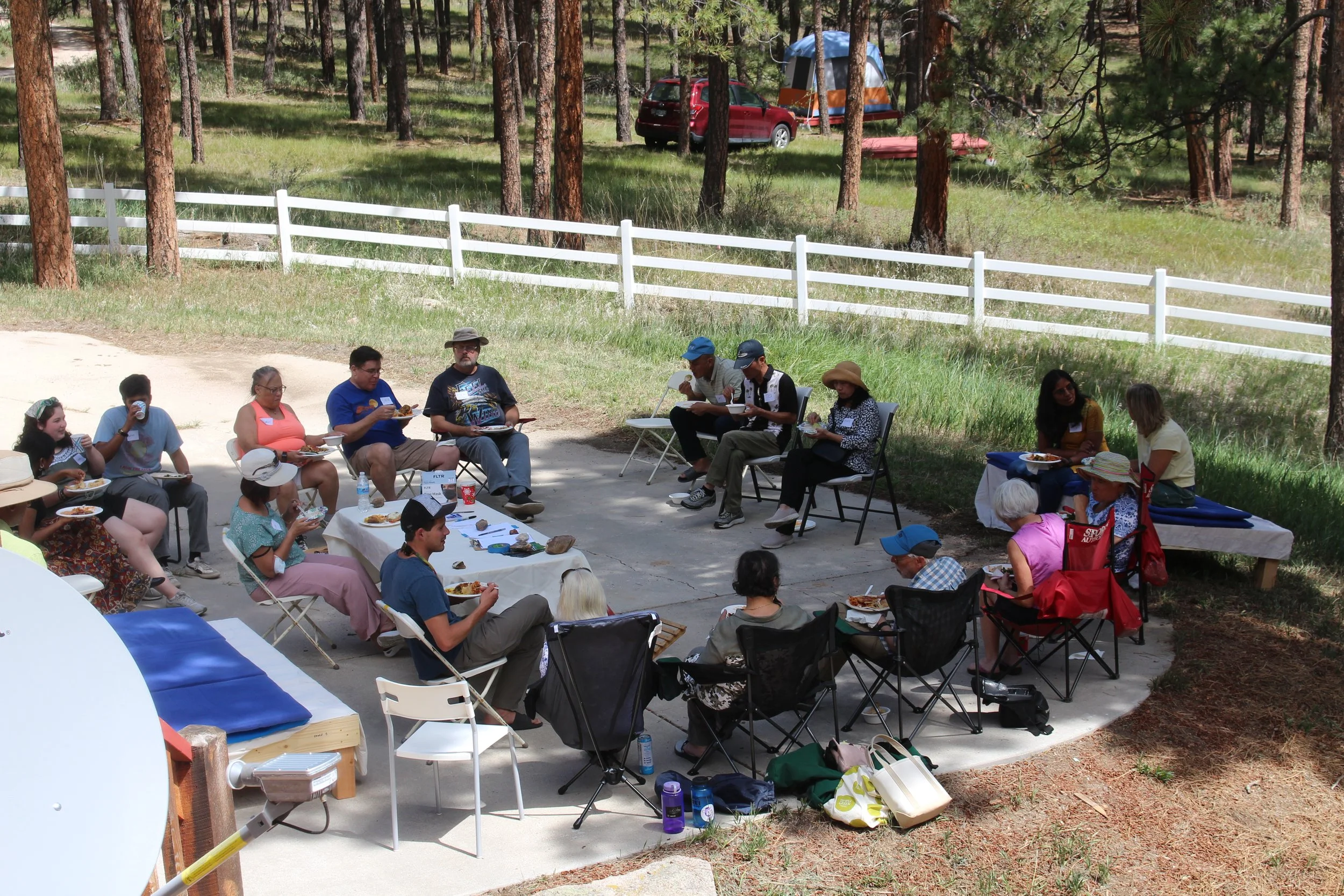 Old students gathering outside to enjoy a potluck during an open house. 
