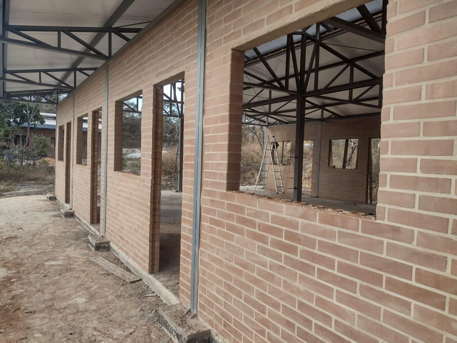 Dormitory walls closing in ecological brick, with window openings framed for each room.