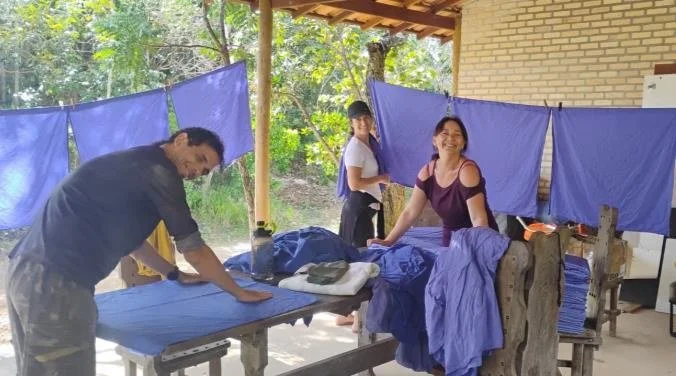 Servers washing, counting and folding cushion covers during a service period. Much of the center has been built and maintained this way.