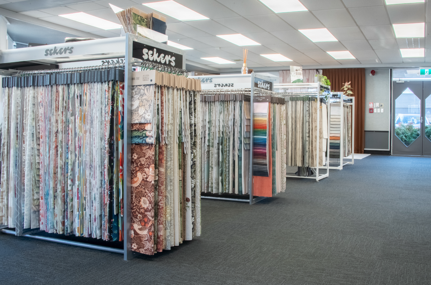 Fabric and curtain sample display racks in a fabric store.