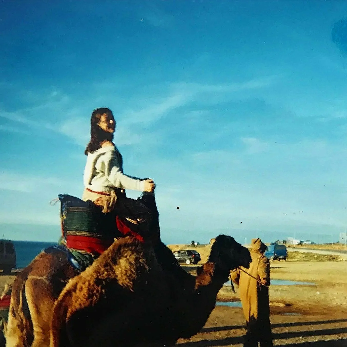 Quinn Hannum riding a camel through the Moroccan desert, Tangier.
