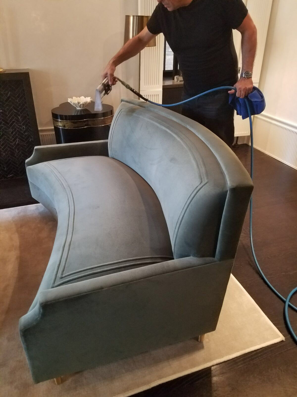 Treating the custom sofa with Scotch Guard to prevent staining.
