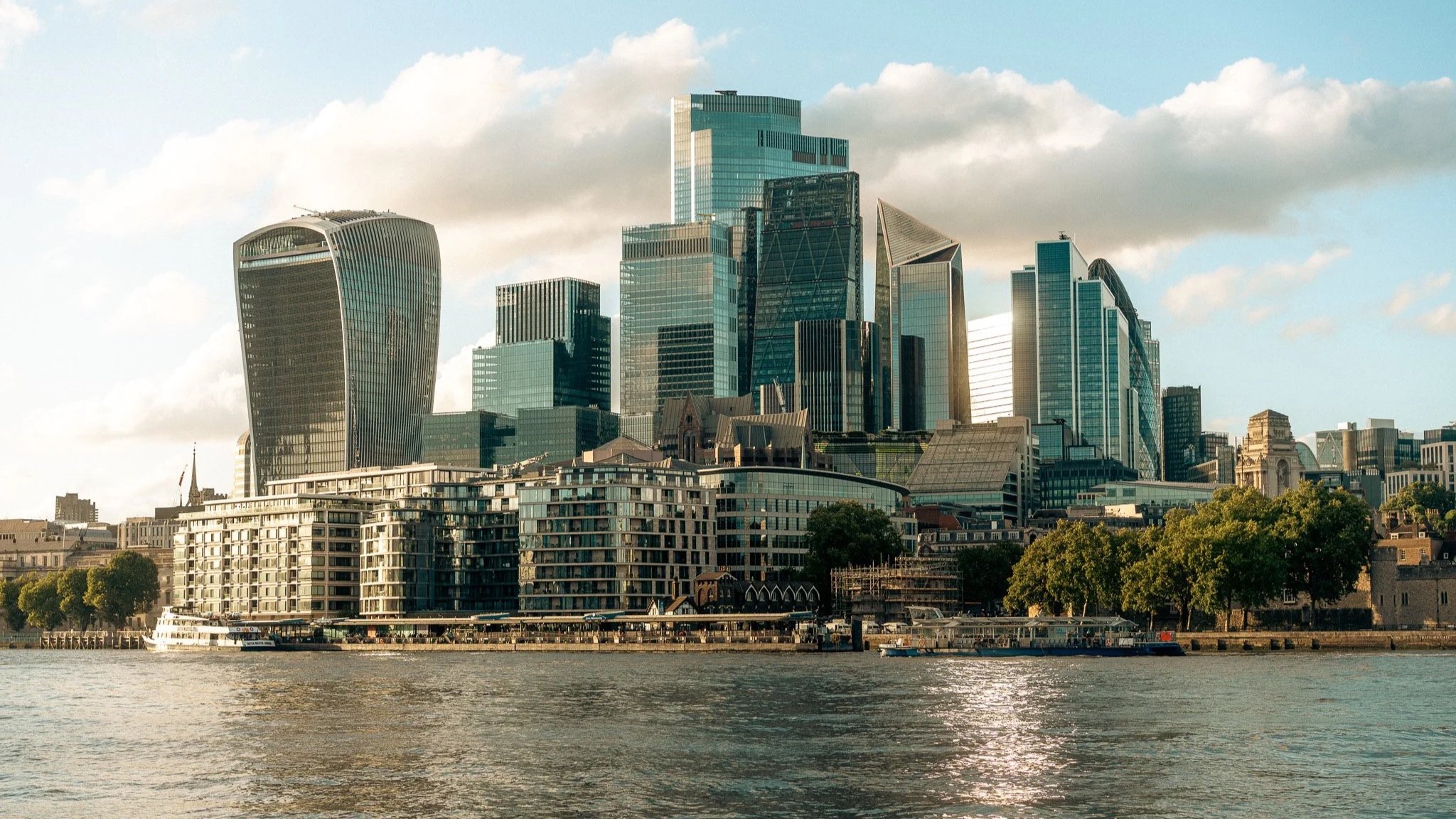 The London skyline lit up by golden hour across the River Thames.