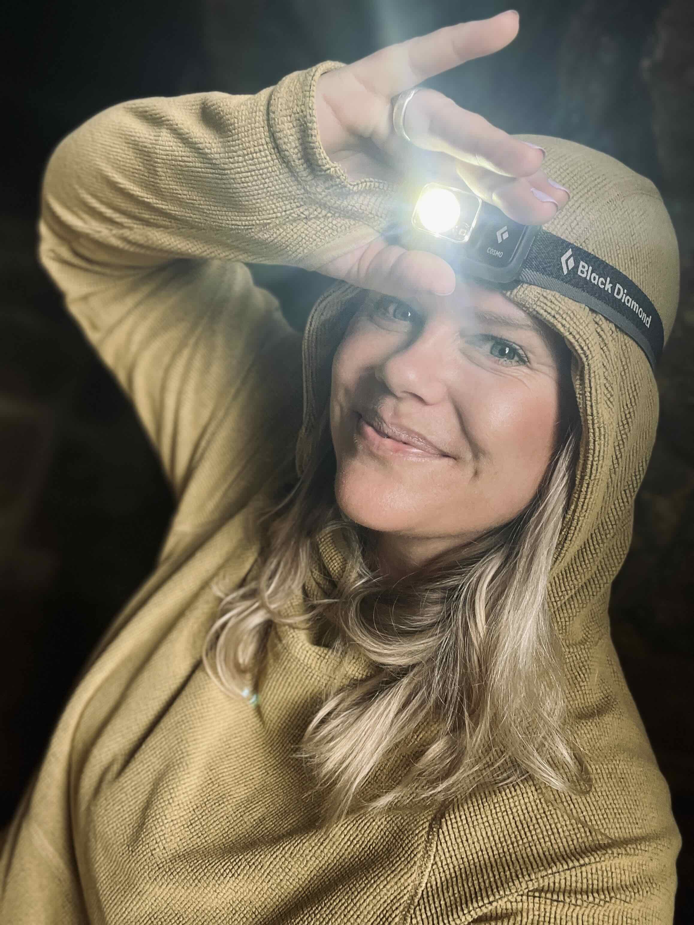 Tara wears Zorali Airgrid Fleece with a headtorch while going through dark tunnels