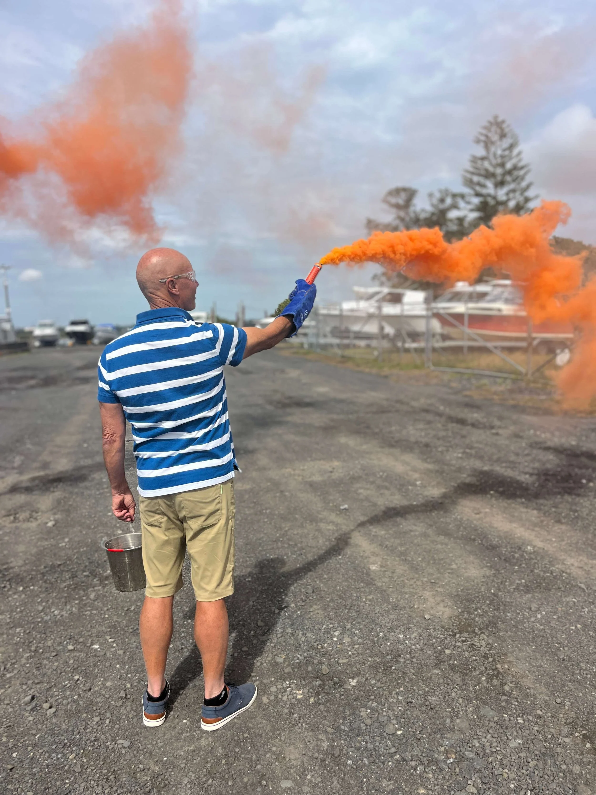 Sailor testing a handheld distress smoke flare
