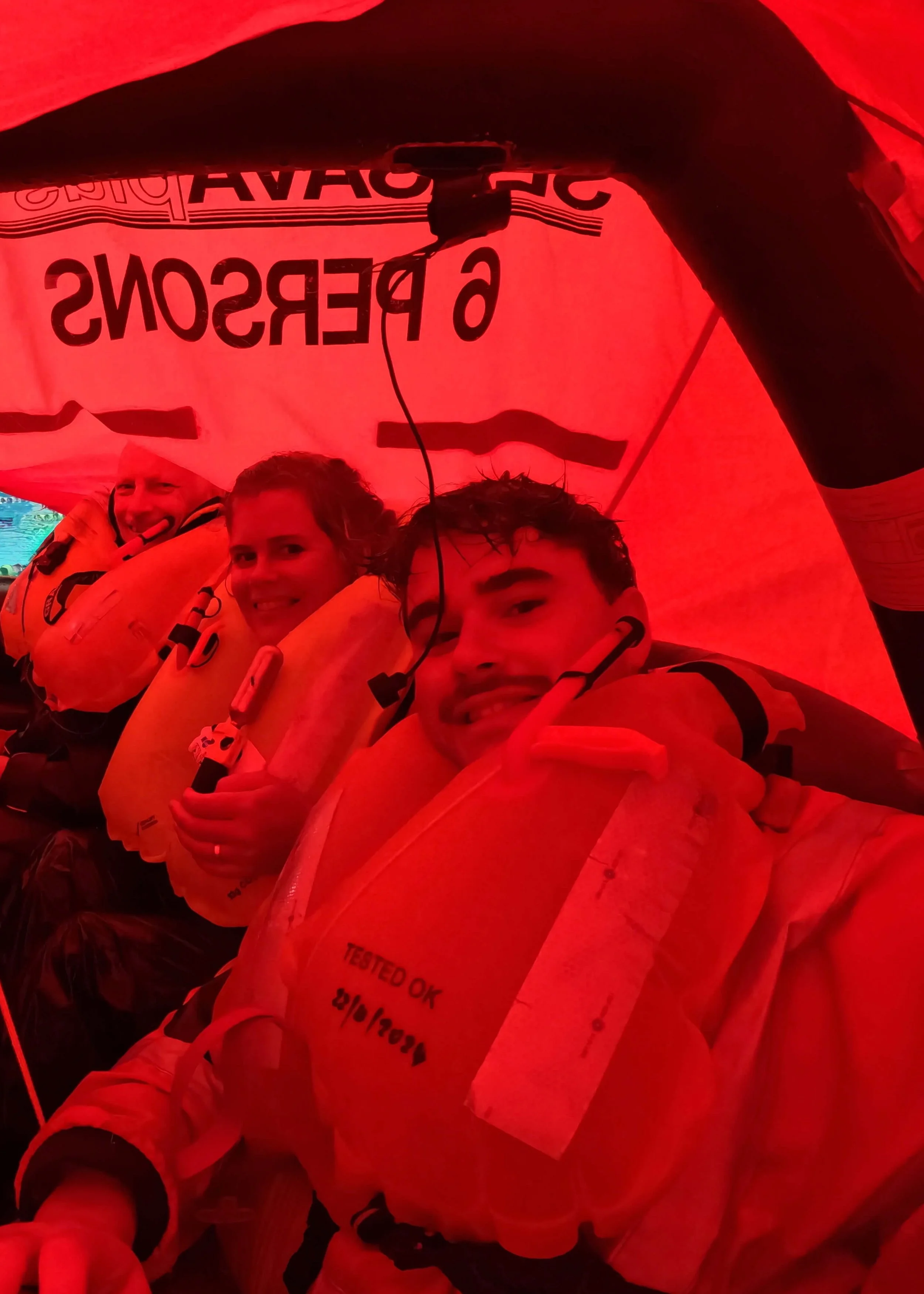 Tara Cooney practicing survival in a liferaft with sailors