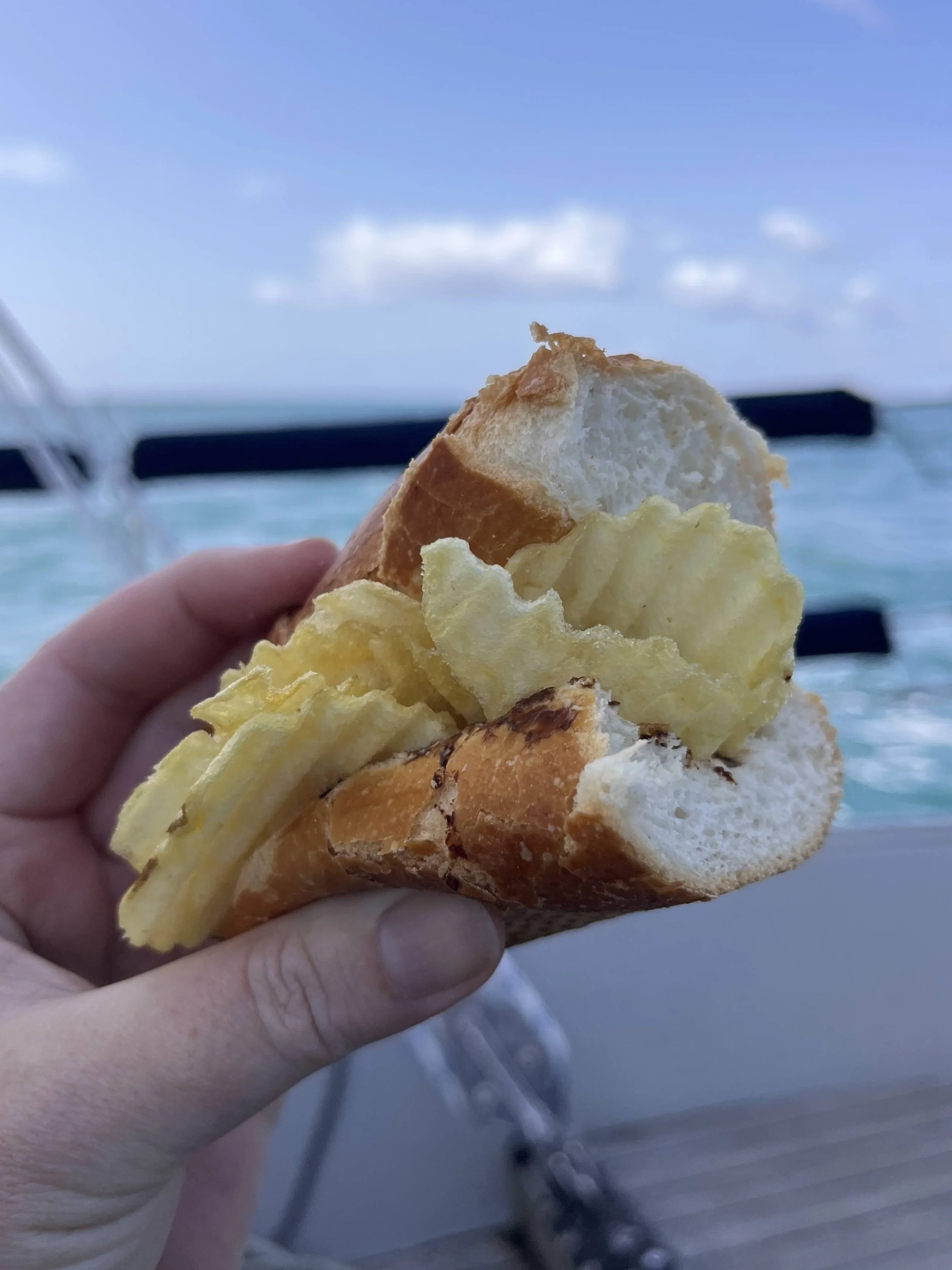 Salt & Vinegar chips in a white roll at sea