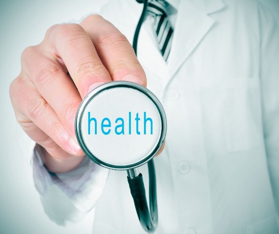 Doctor holding a stethoscope with the word 'health' displayed on the diaphragm.