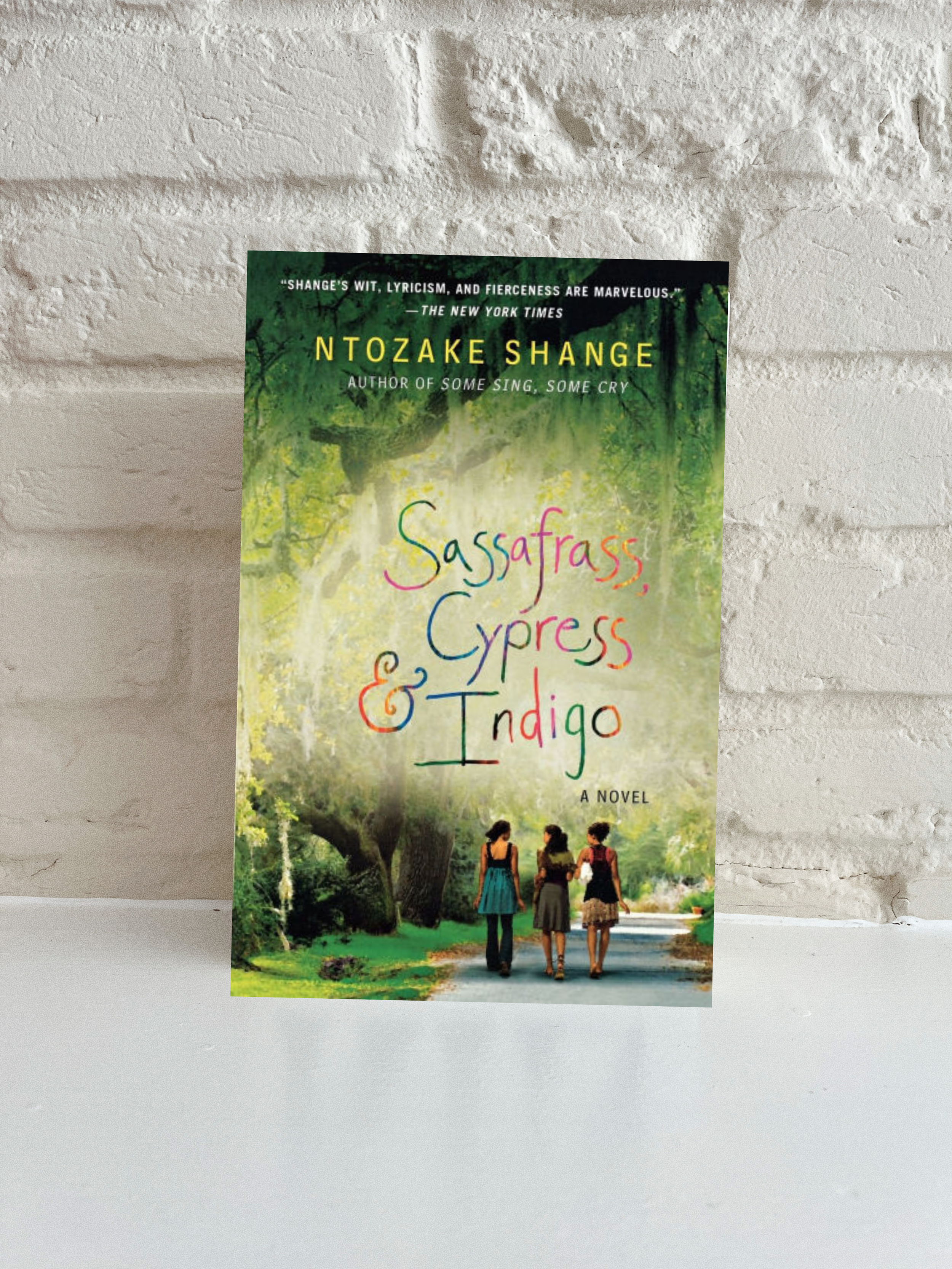 Sassafrass, Cypress & Indigo by Ntozake Shange on white brick background