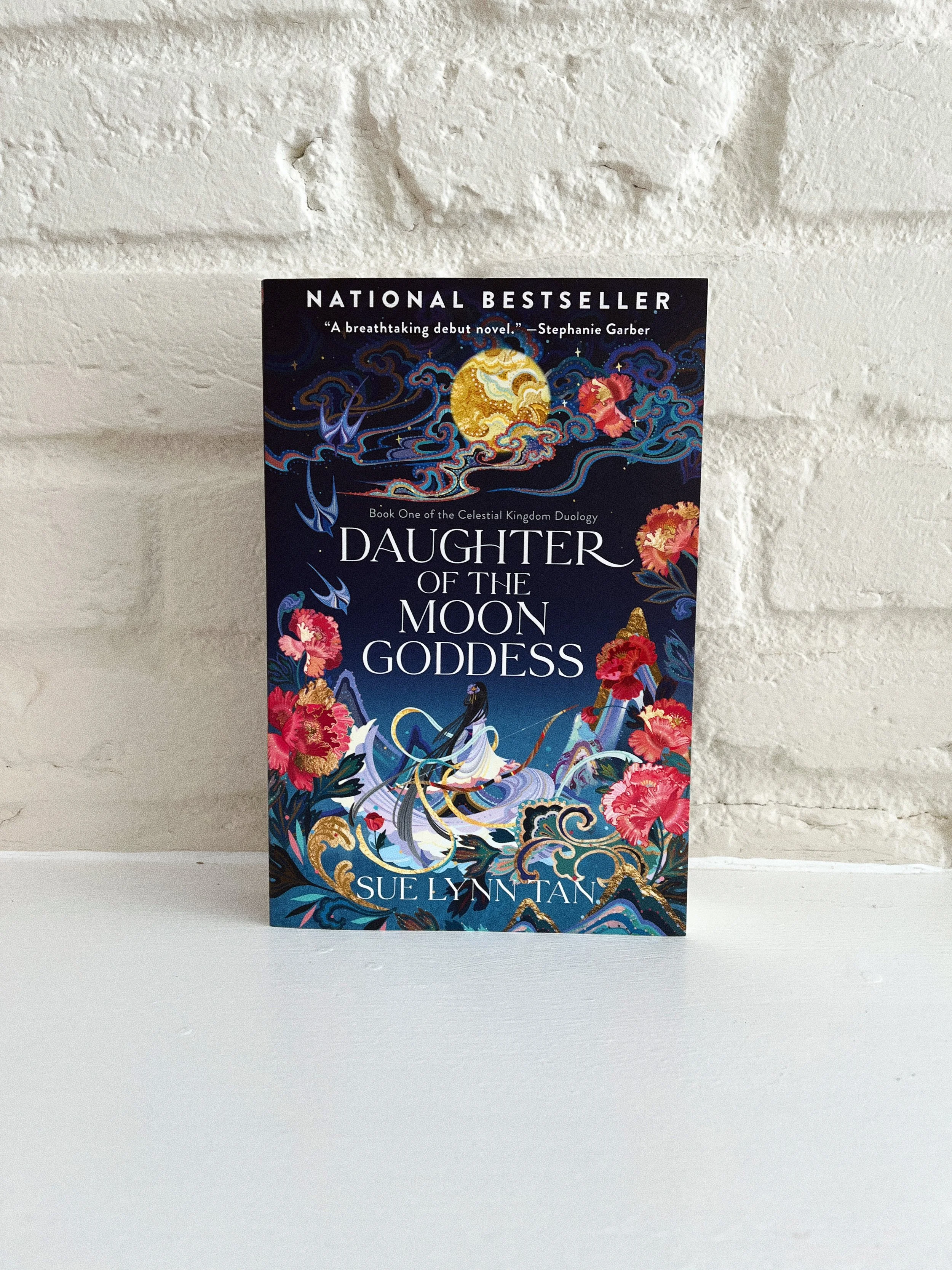 Daughter of the Moon Goddess by Sue Lynn Tan on white brick background