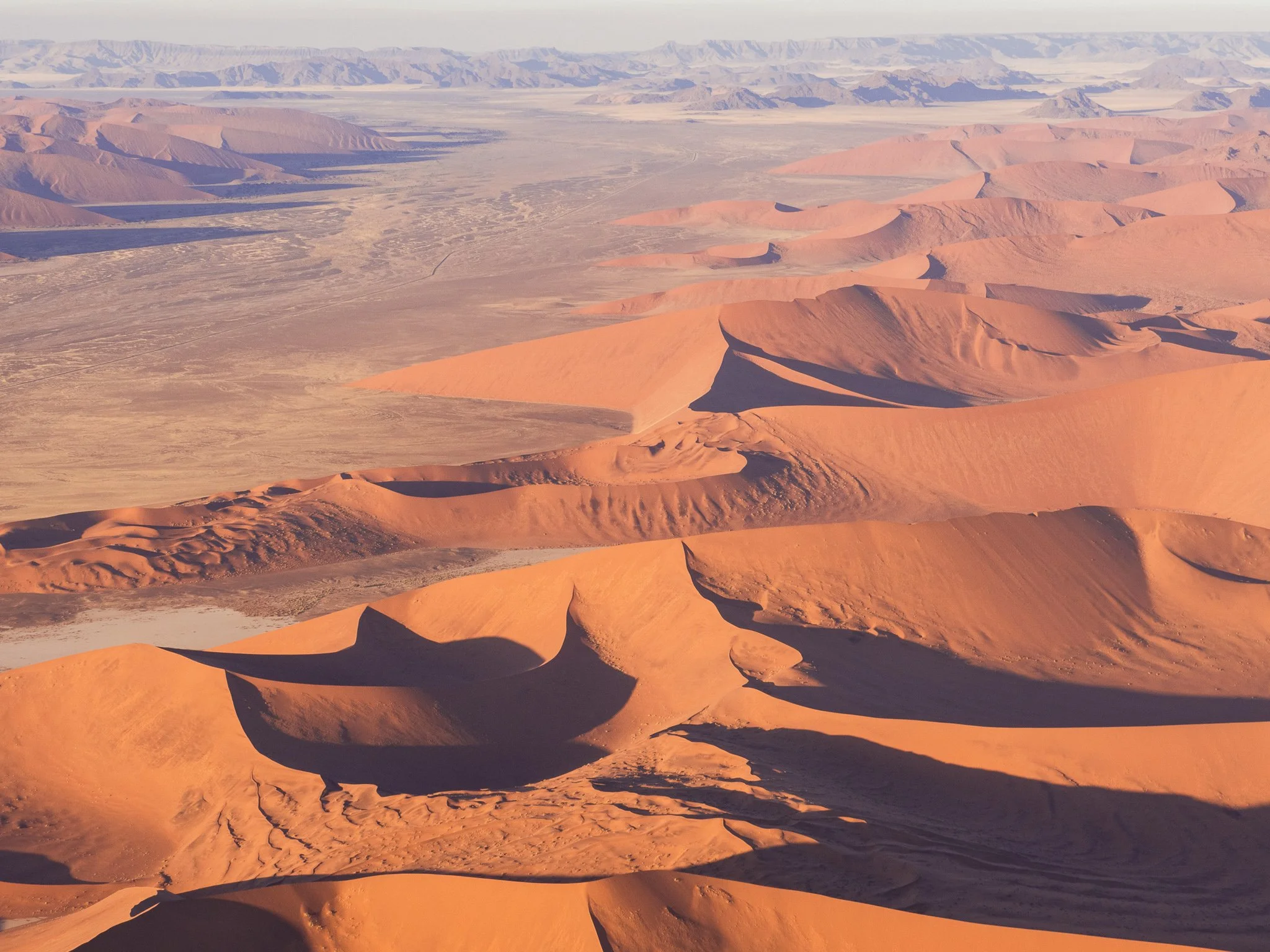 People walking on the Iconic red sand dunes of Namibia