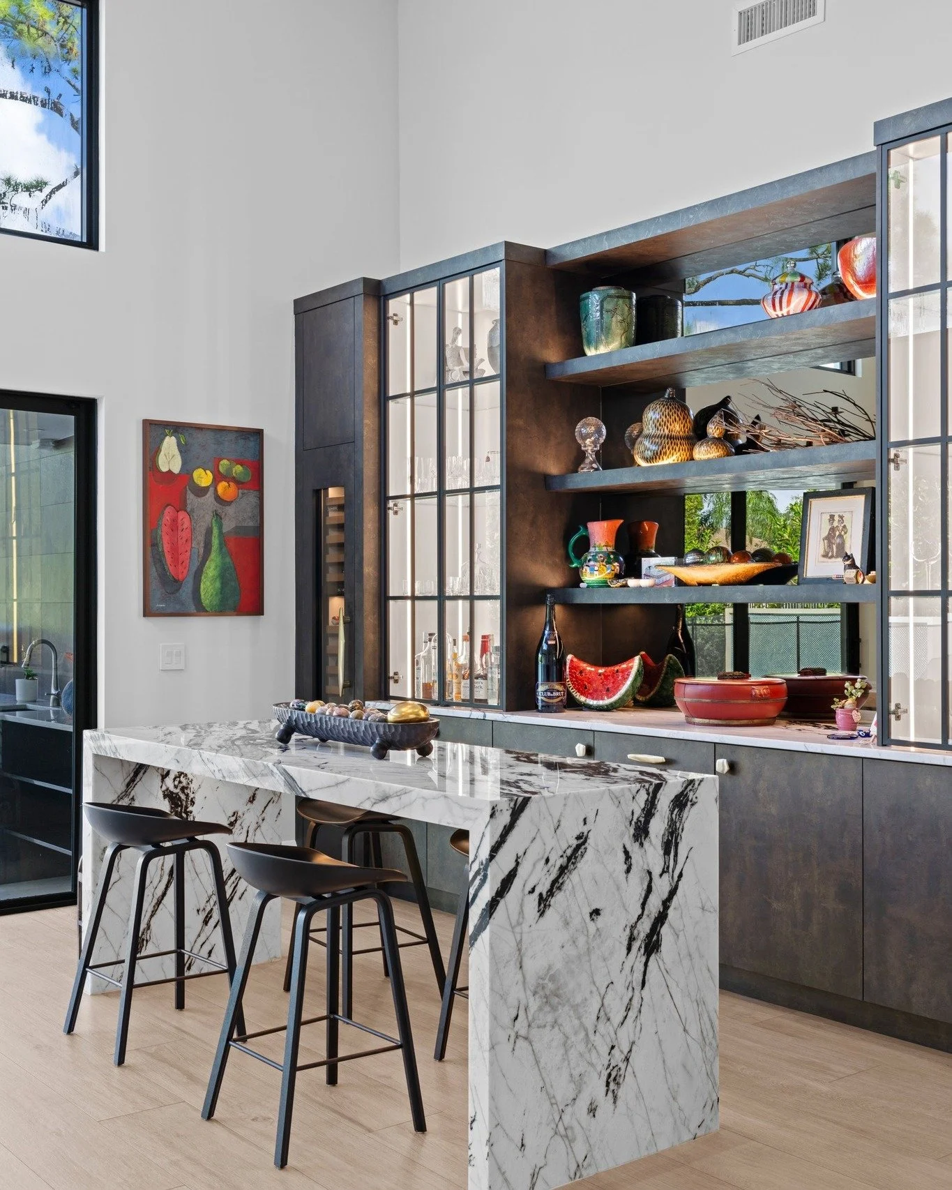 Bar by design. Gallery by experience. 🥂🖼️

We love how this multi-functional hub anchors the center of the home. Whether you&rsquo;re pouring a drink or reminiscing over travels past, this space proves that a home bar can be a work of art in itself