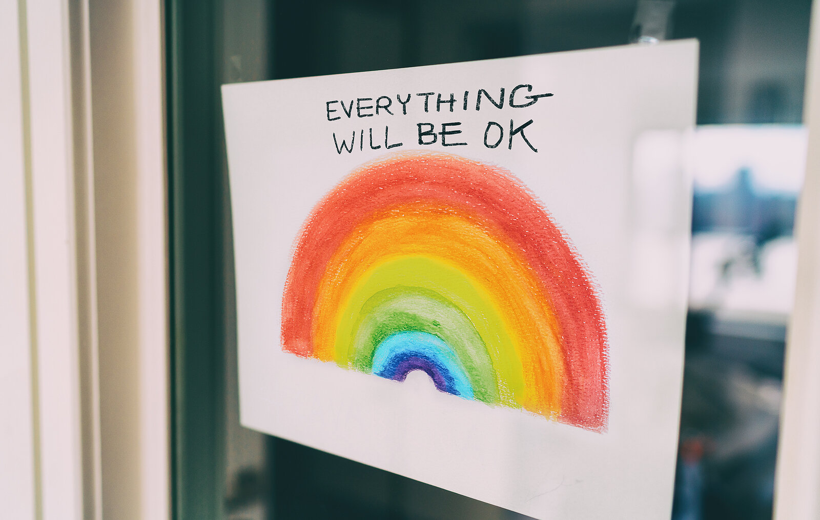Drawing of a rainbow with phrase “Everything will be ok” written on the page. The paper is taped to a window to be seen by people walking by. This could represent therapists in Mid Mo providing support for members of the LGBTQ community. Aspire Coun…