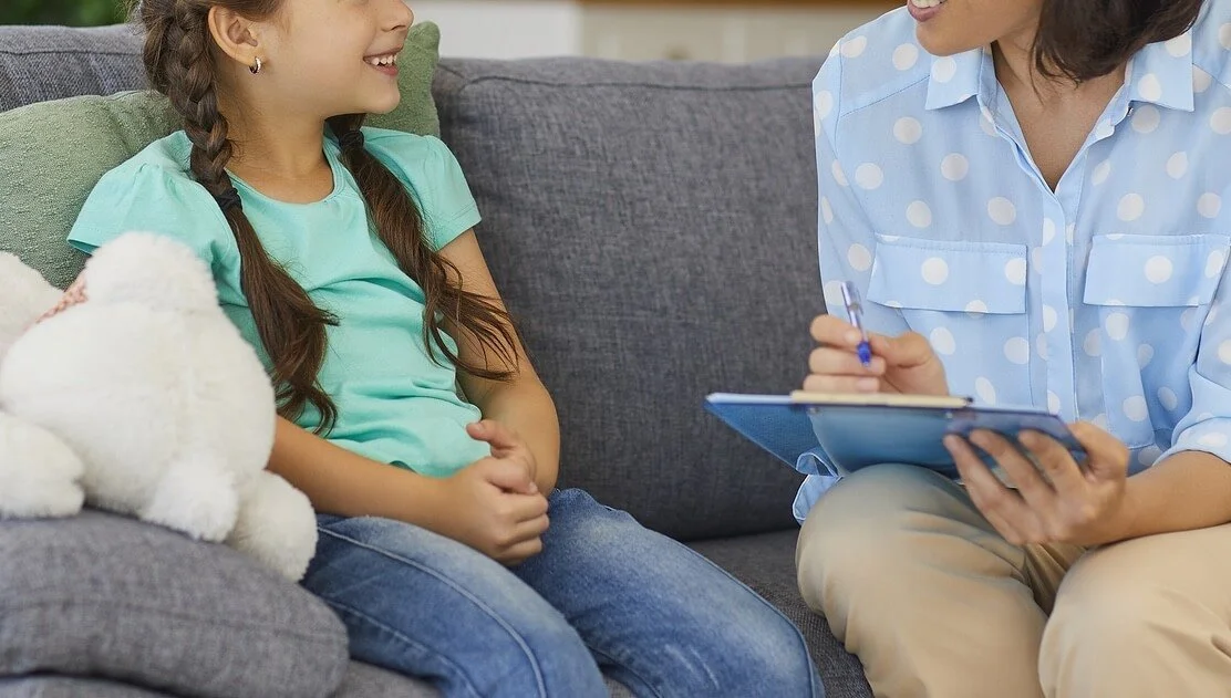 Child talking comfortably with a counselor in a warm, supportive setting. Help your child feel heard, supported, and empowered with trusted child counseling in Columbia, MO that meets them where they are.