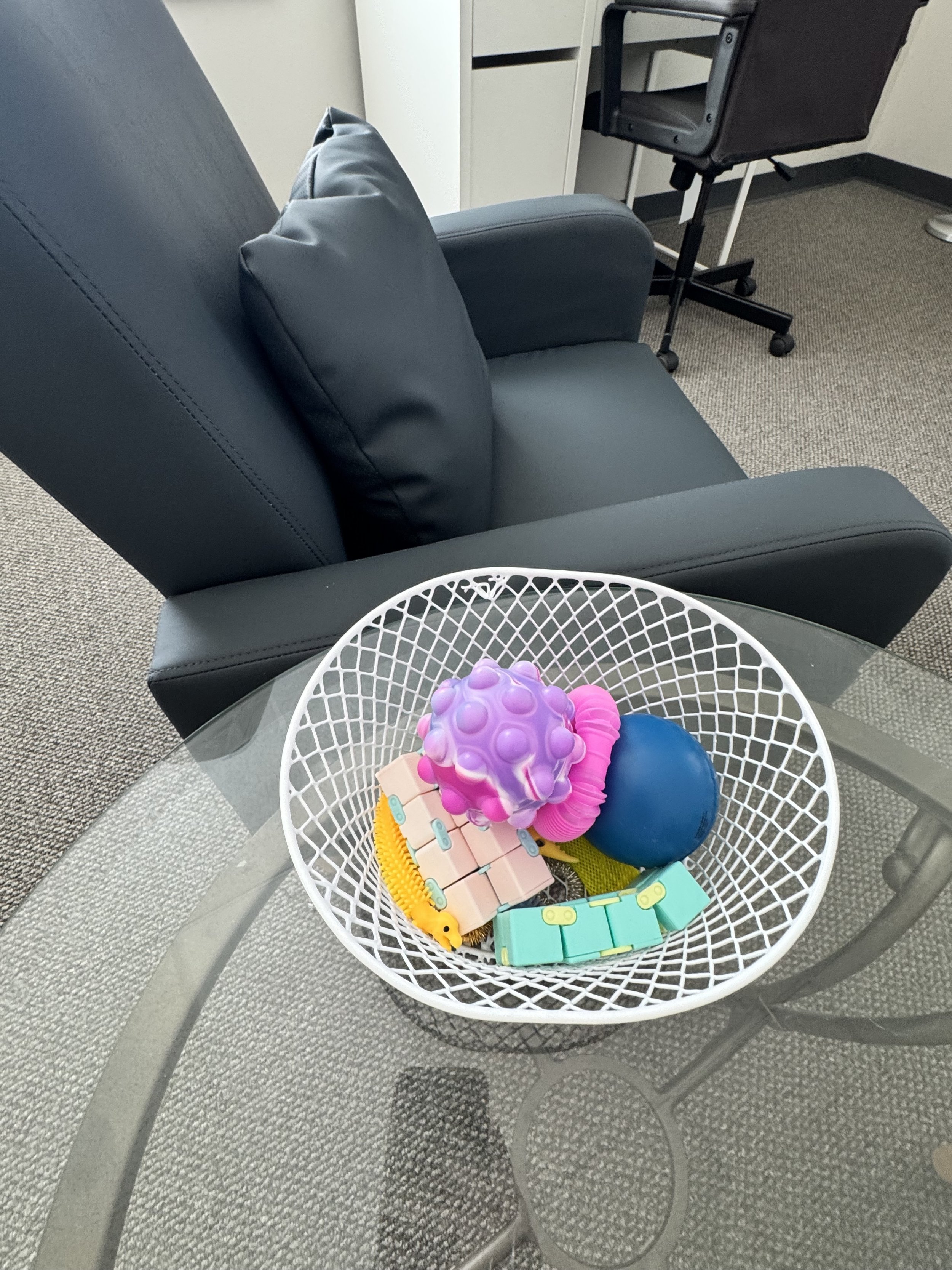 A small basket of fidgets showing that most rooms in our counseling space have fidgets to meet each person's sensory needs.