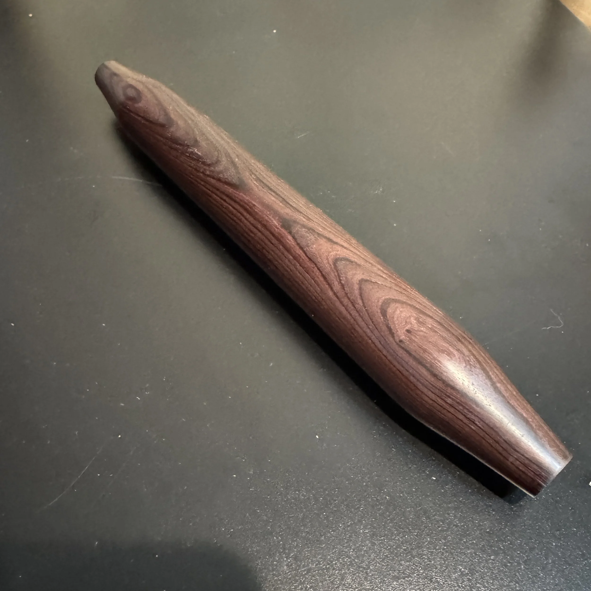 Hand-turned tortilla rolling pin made from Allen Purpleheart, showing smooth dark grain.