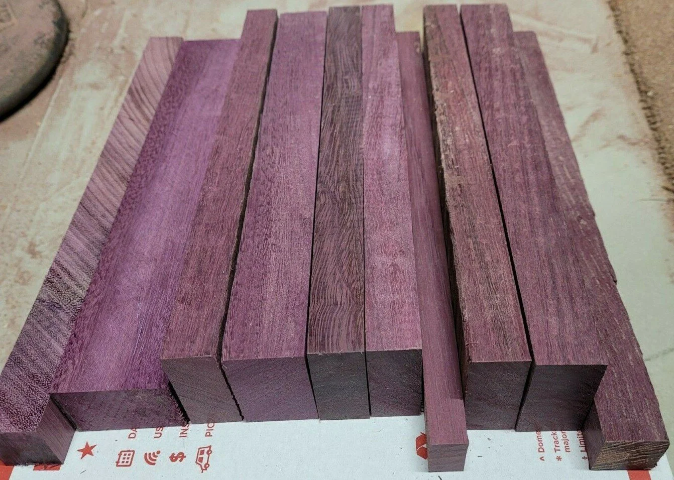 Hefty Purpleheart pieces from Mr. Allen’s shop, each about 2 inches thick and 2–3 inches wide, showing rich natural purple grain.