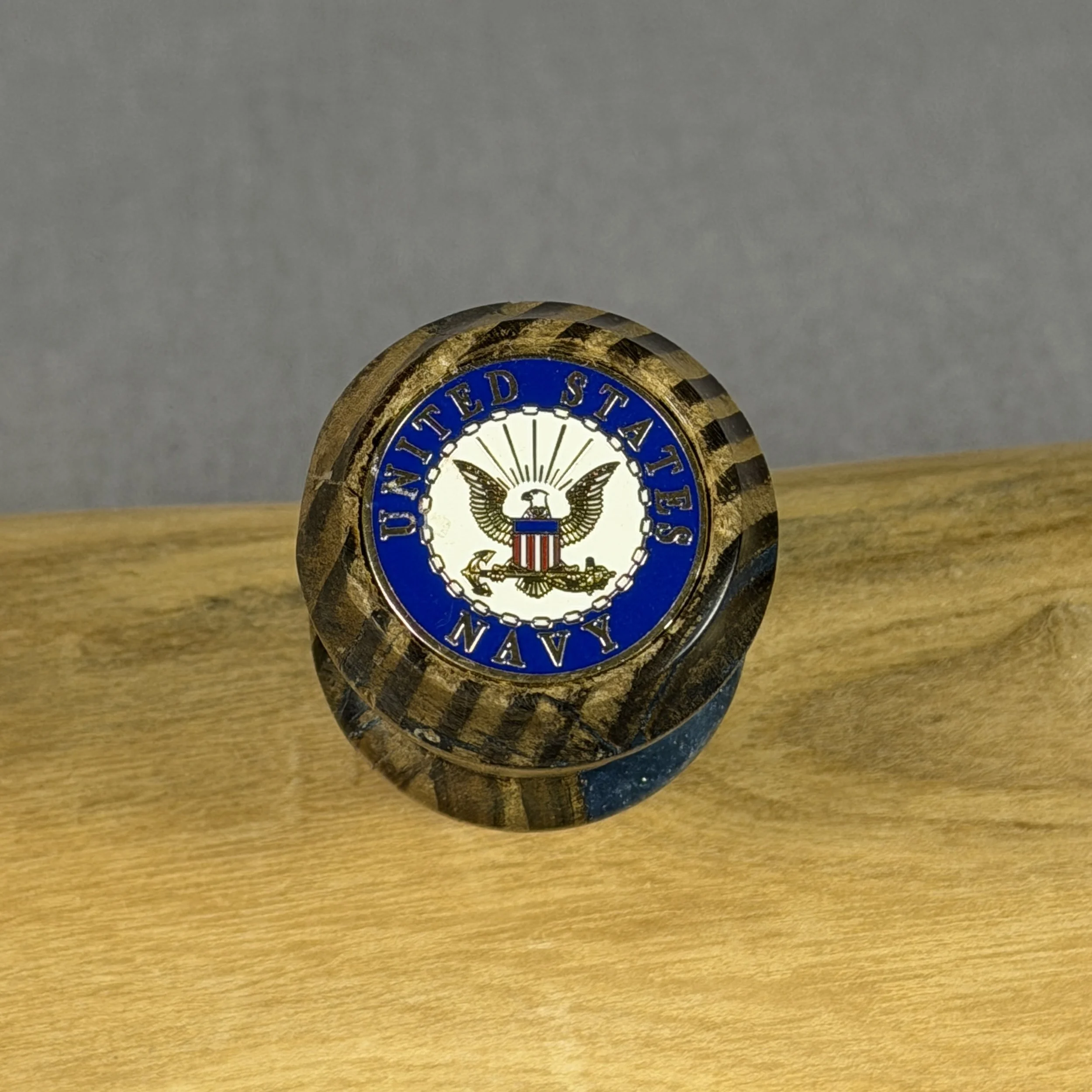 Top view of USS Texas reclaimed deck wood whiskey topper showing United States Navy emblem and blue epoxy-filled grain details