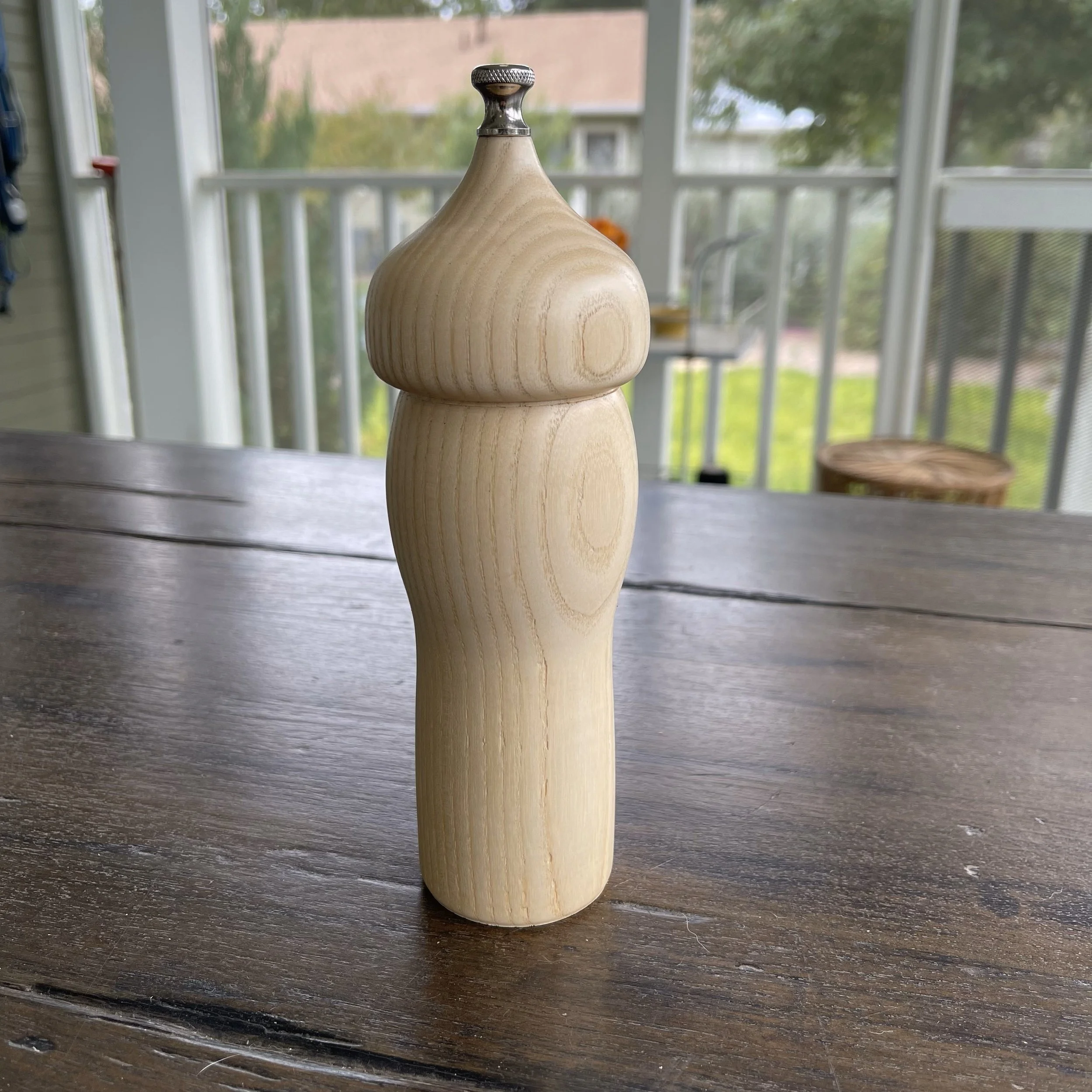 Salt mill turned from reclaimed Allen Ash, highlighting the pale wood grain and smooth hand-turned form.