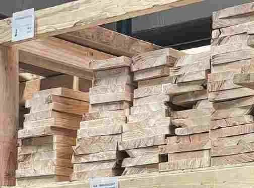 Milled cherry boards from Mr. Allen’s reclaimed inventory, stacked on shop racks with clean edges and grain visible.