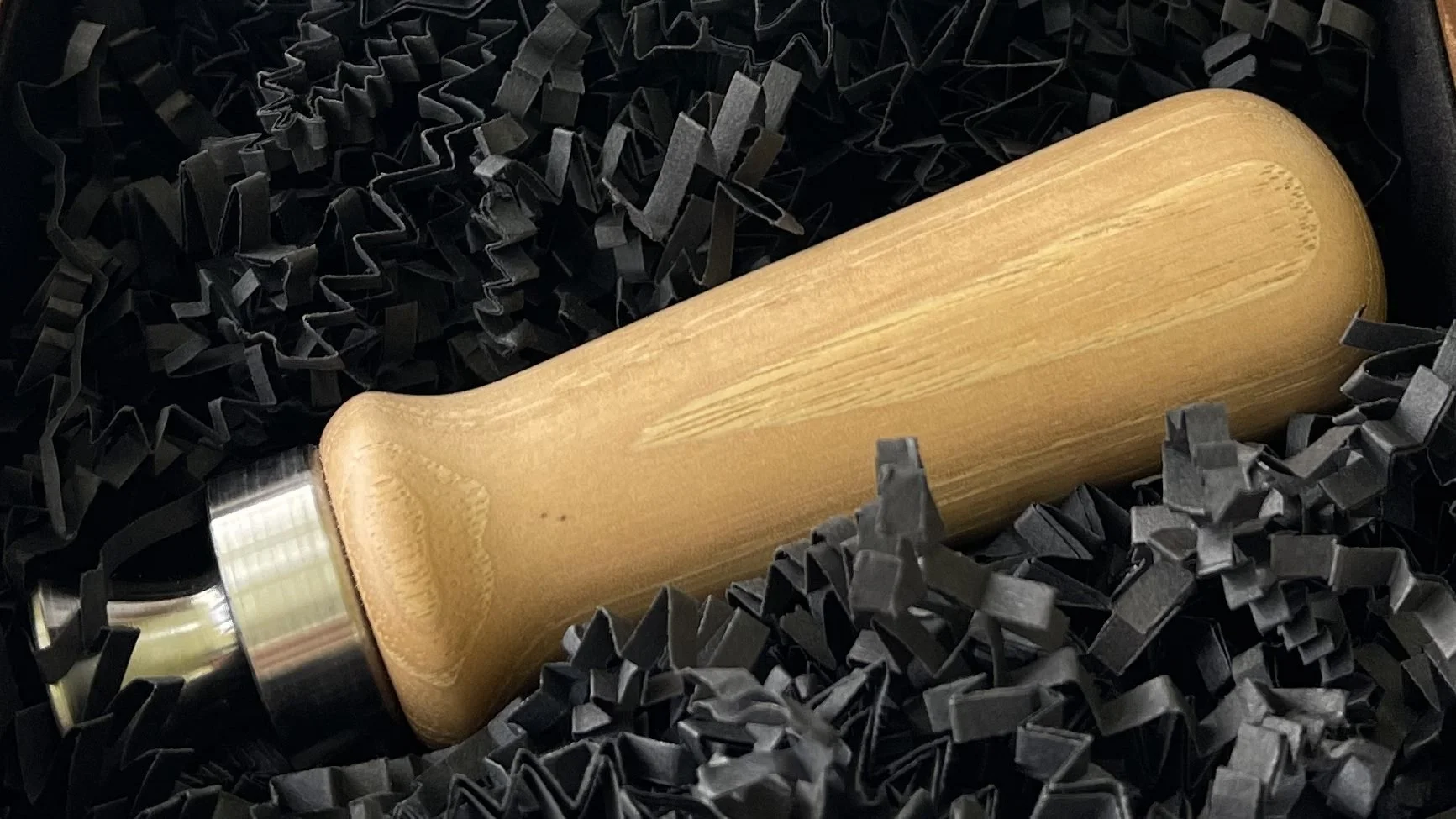 Bottle cap opener made from reclaimed Allen Ash, showing the pale wood grain and smooth turned handle.