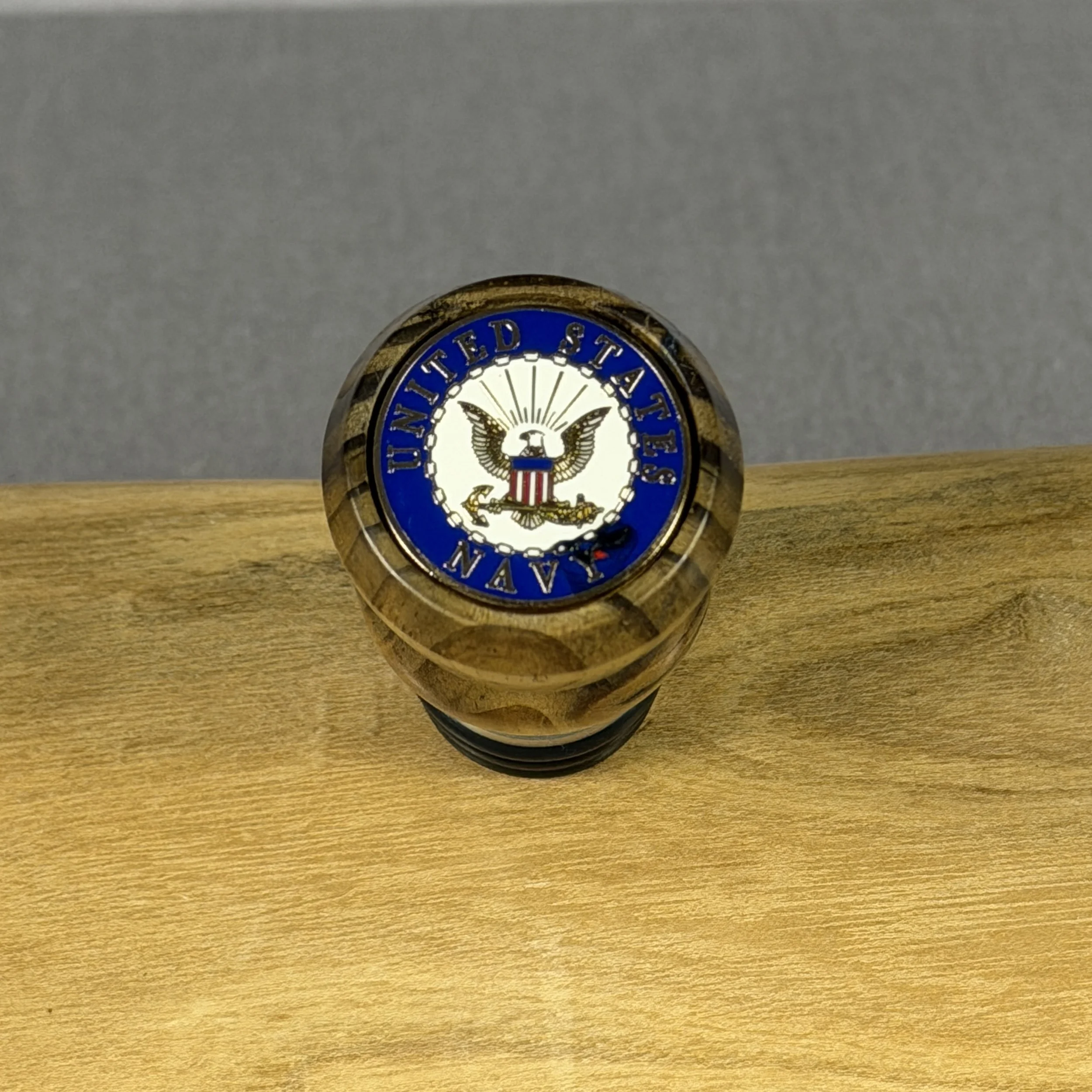 Top view of USS Texas reclaimed deck wood whiskey topper showing the inlaid United States Navy emblem
