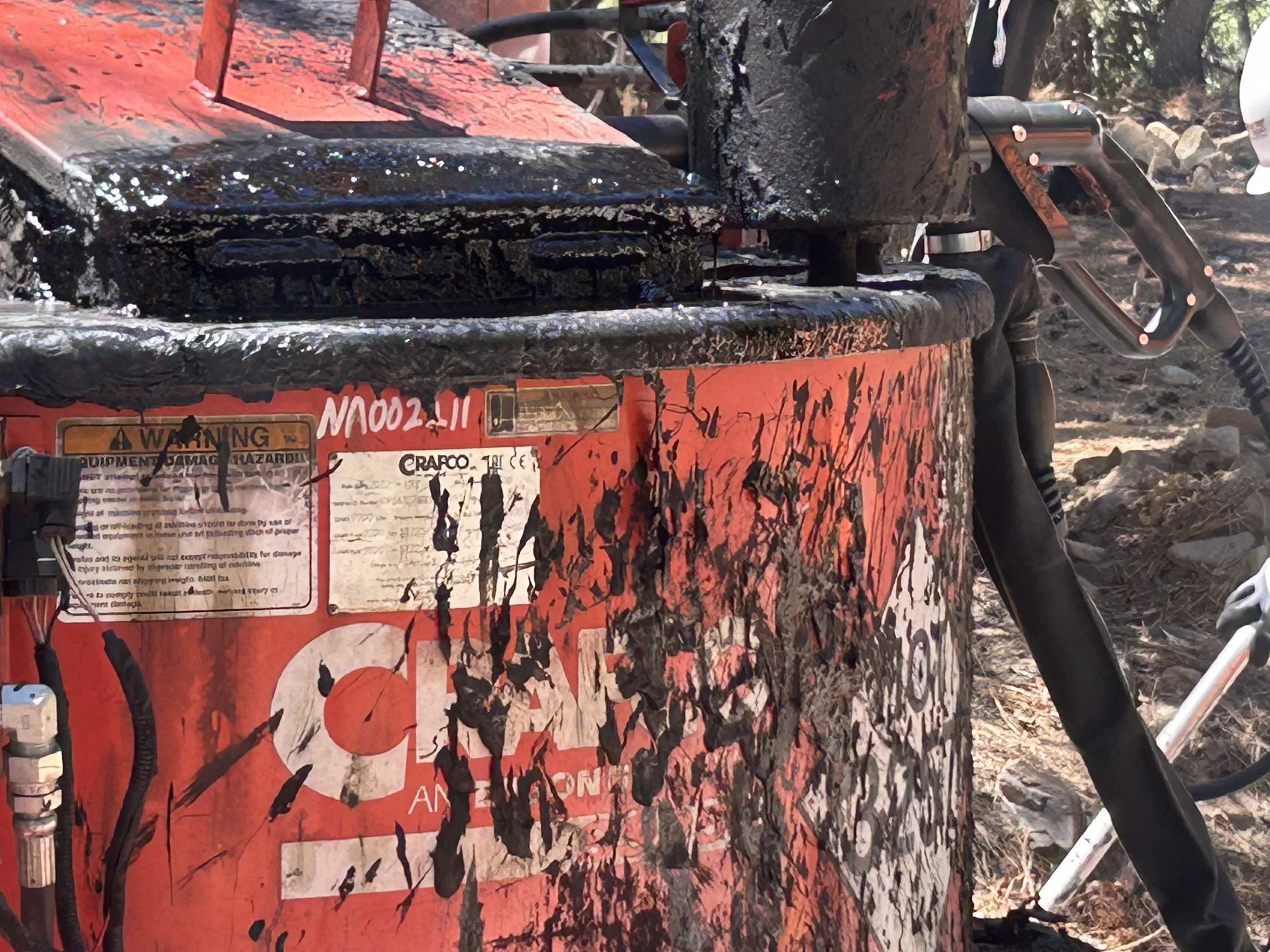 A red tank of asphalt tar.