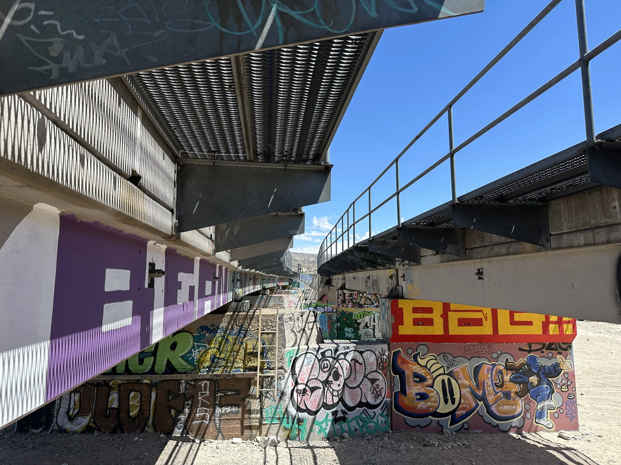 Street art pictures under the train tracks.