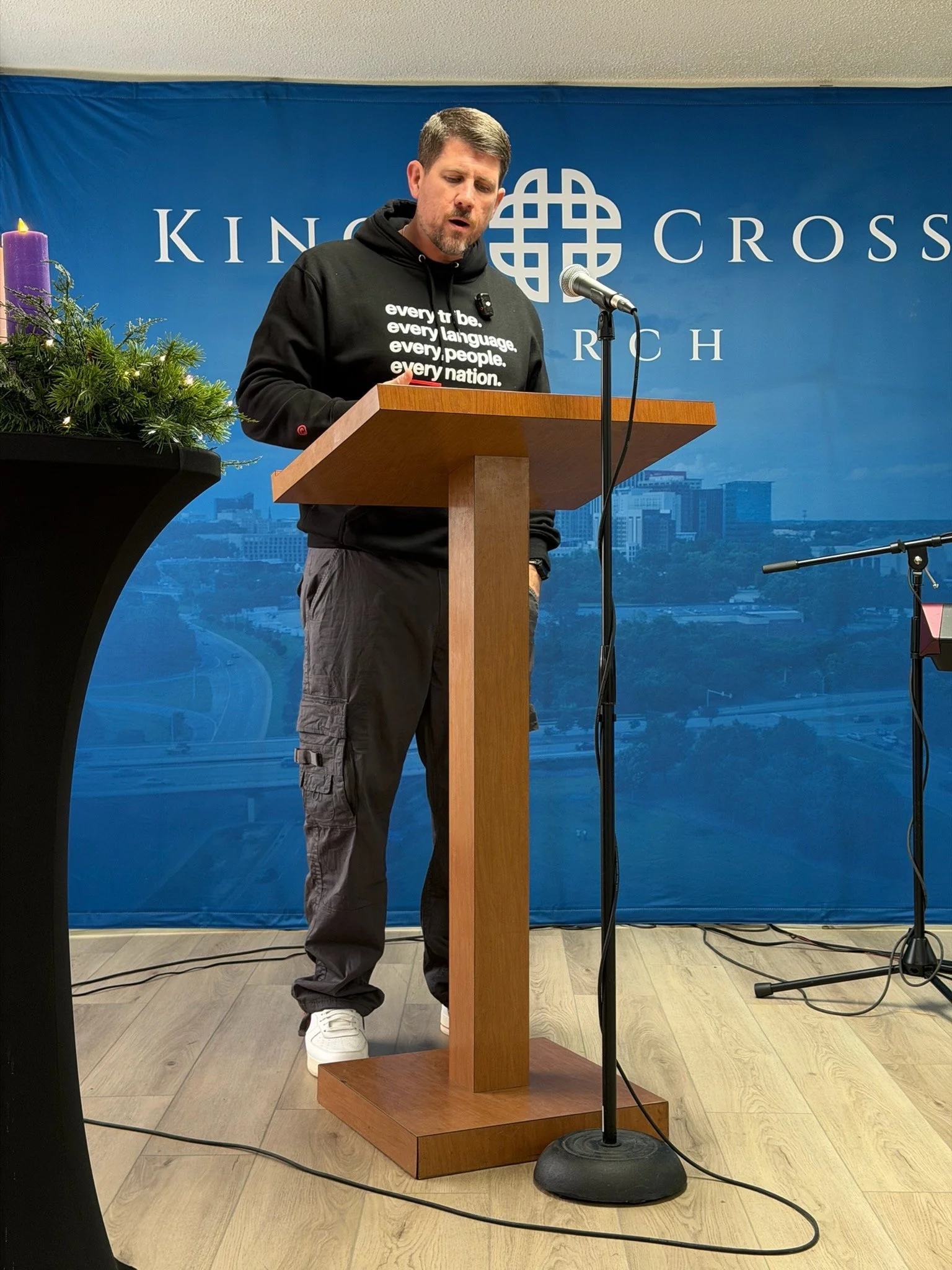 Man preaching in every 2.0 onyx hoodie.