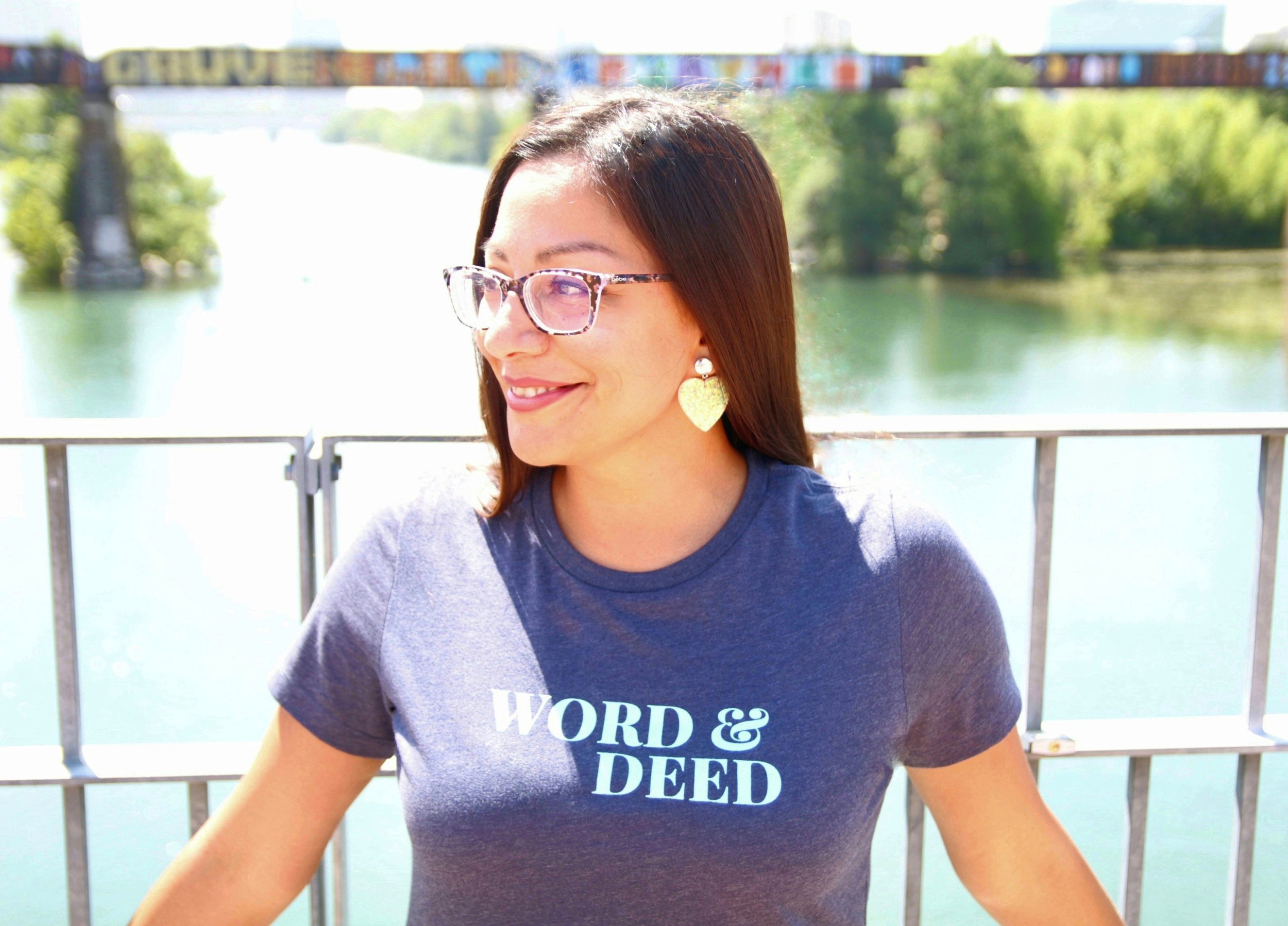 Young Woman wearing the WORD & DEED Women's Heather Navy and Cool Mint Shirt