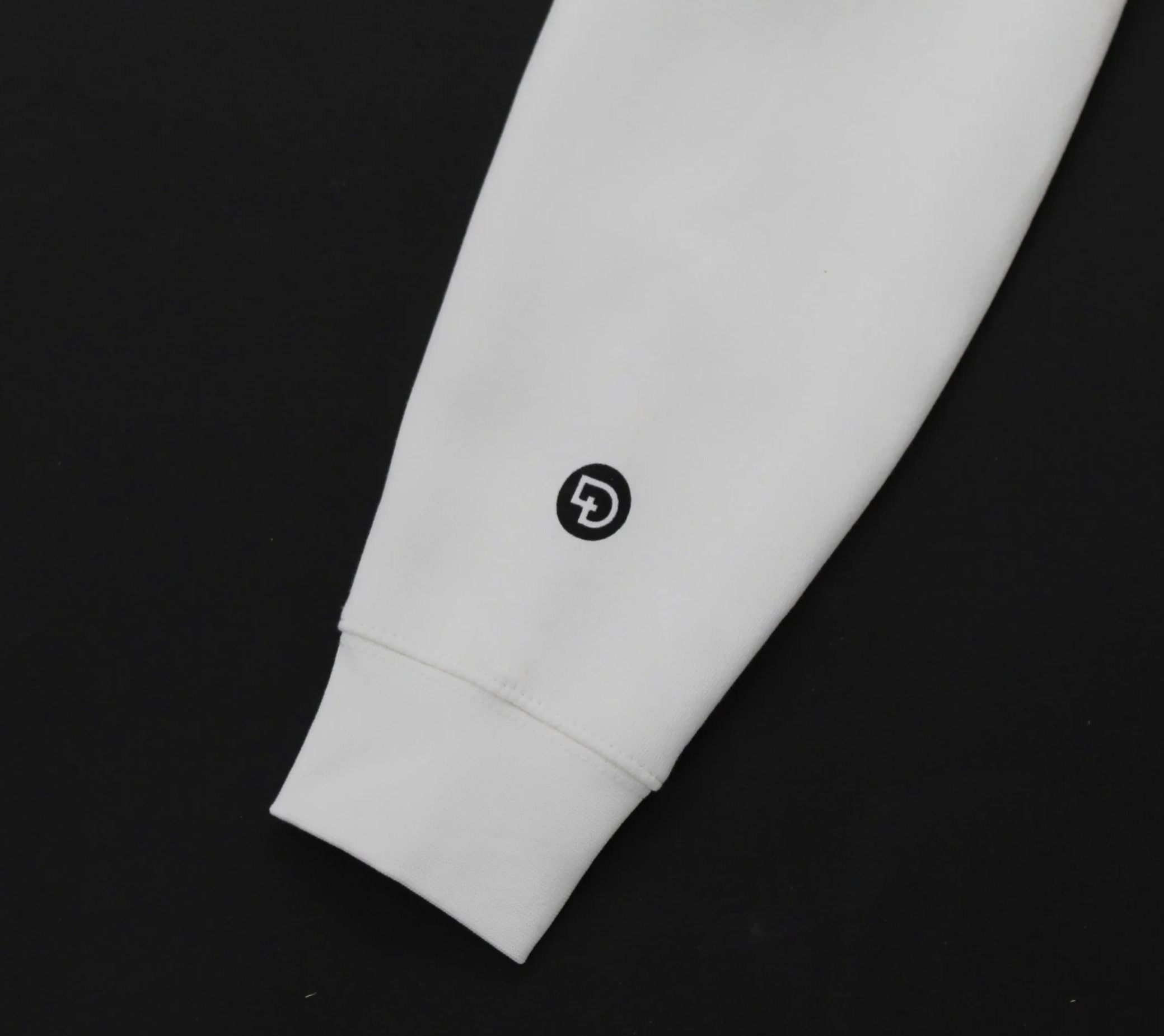 Close‑up of DIGNIY x WORTH logo on sleeve of Christian hoodie