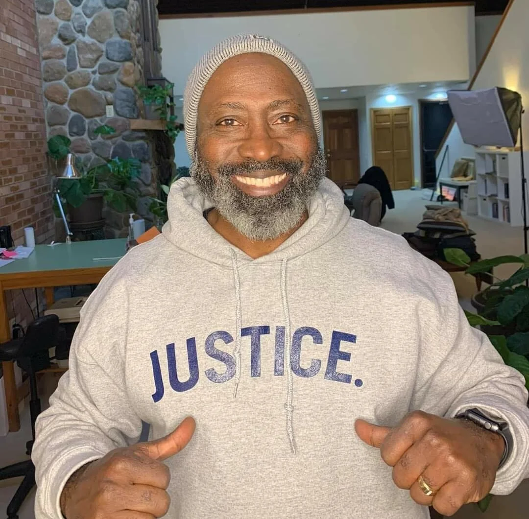 Man in grey JUSTICE. Hoodie