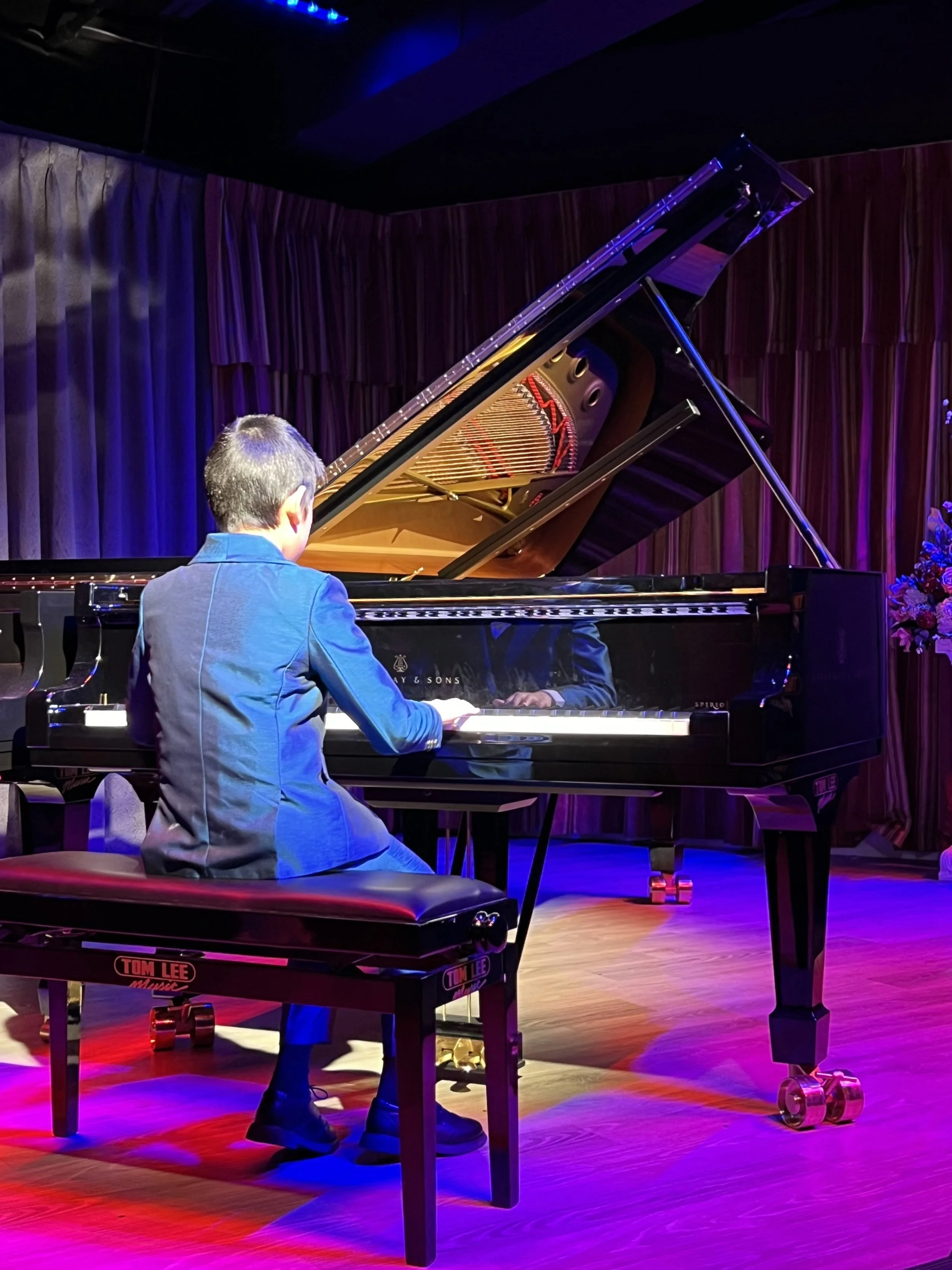 student performing at piano recital