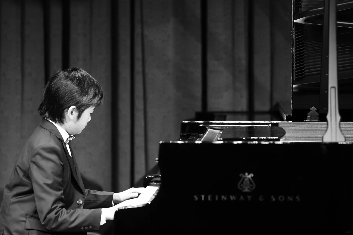 student performing on a steinway grand piano