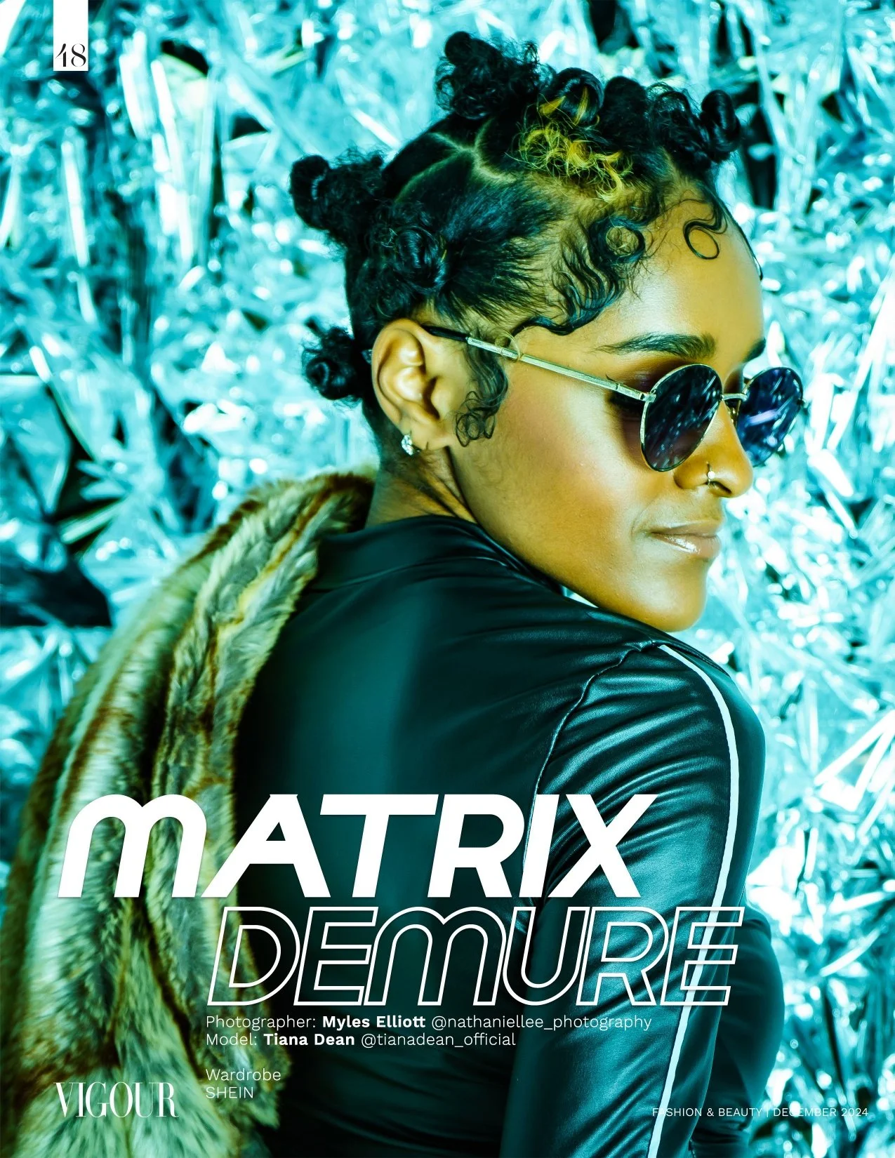 Profile portrait of a woman with curly styled hair wearing sunglasses, earrings, a nose ring, a black leather jacket, and a fur stole, against a metallic silver background.