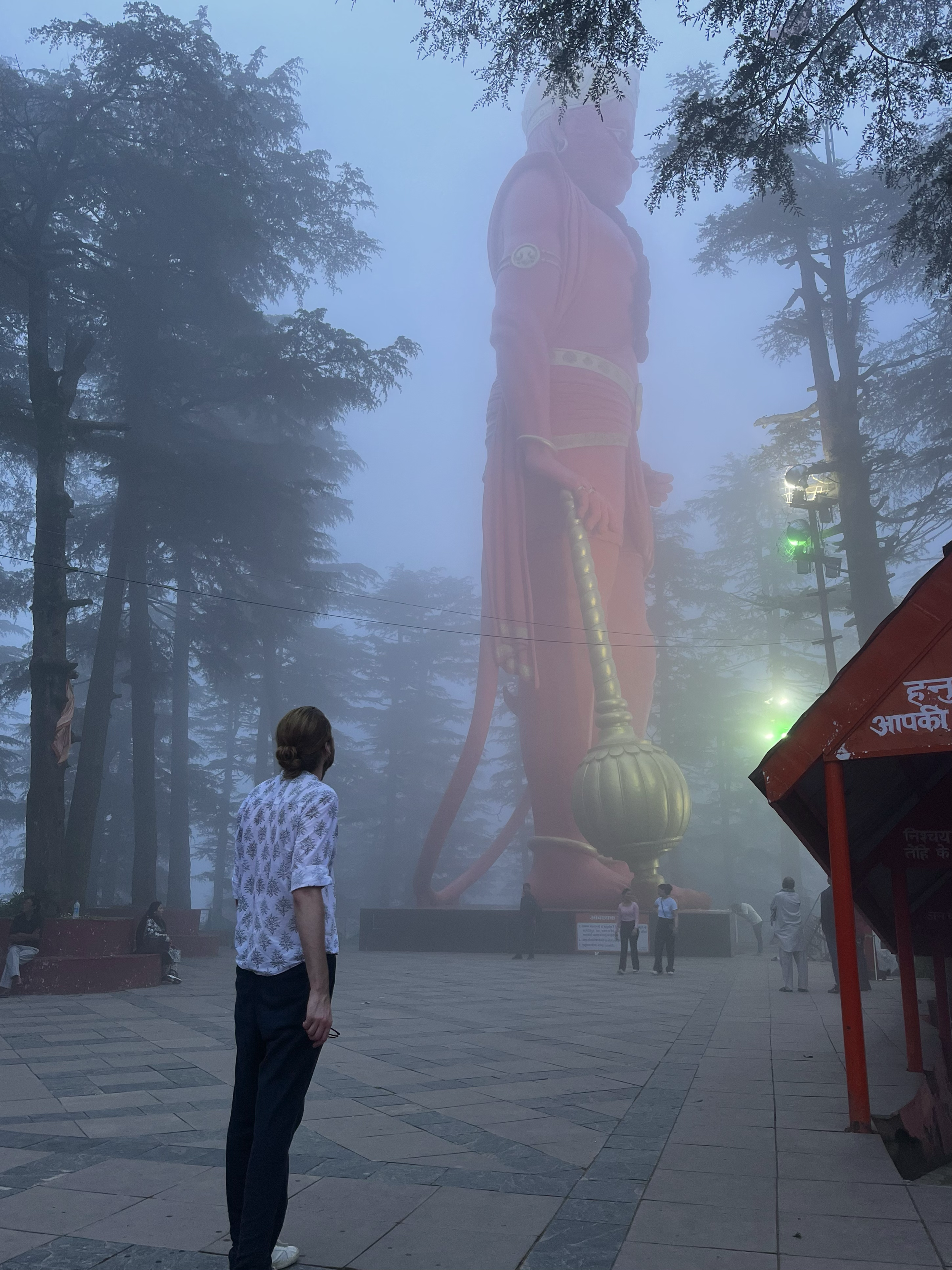 Jordan Quill standing by Hanuman