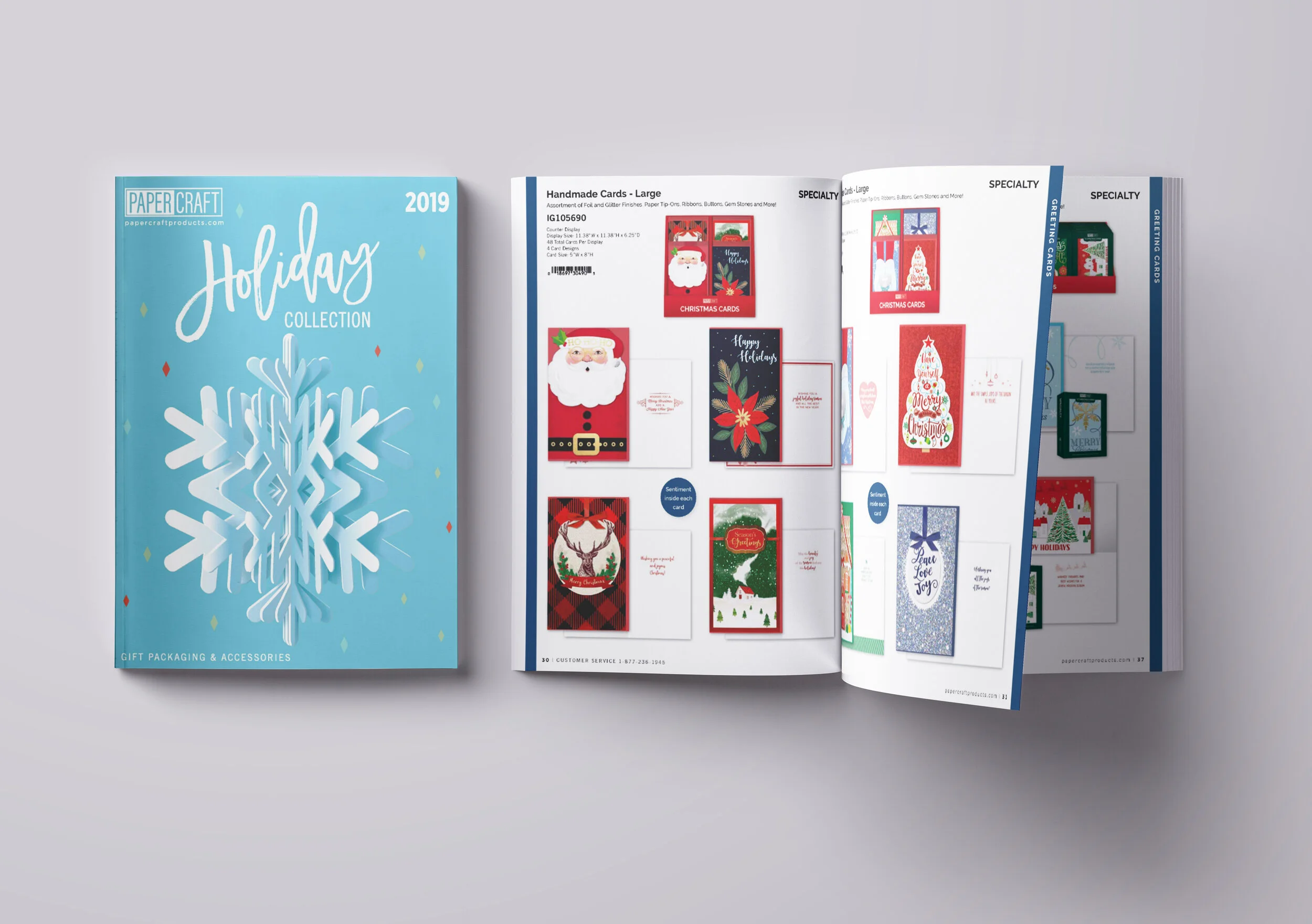 Open holiday greeting card catalog or brochure displaying various Christmas-themed cards with Santa, reindeer, Christmas tree, and winter scenes.